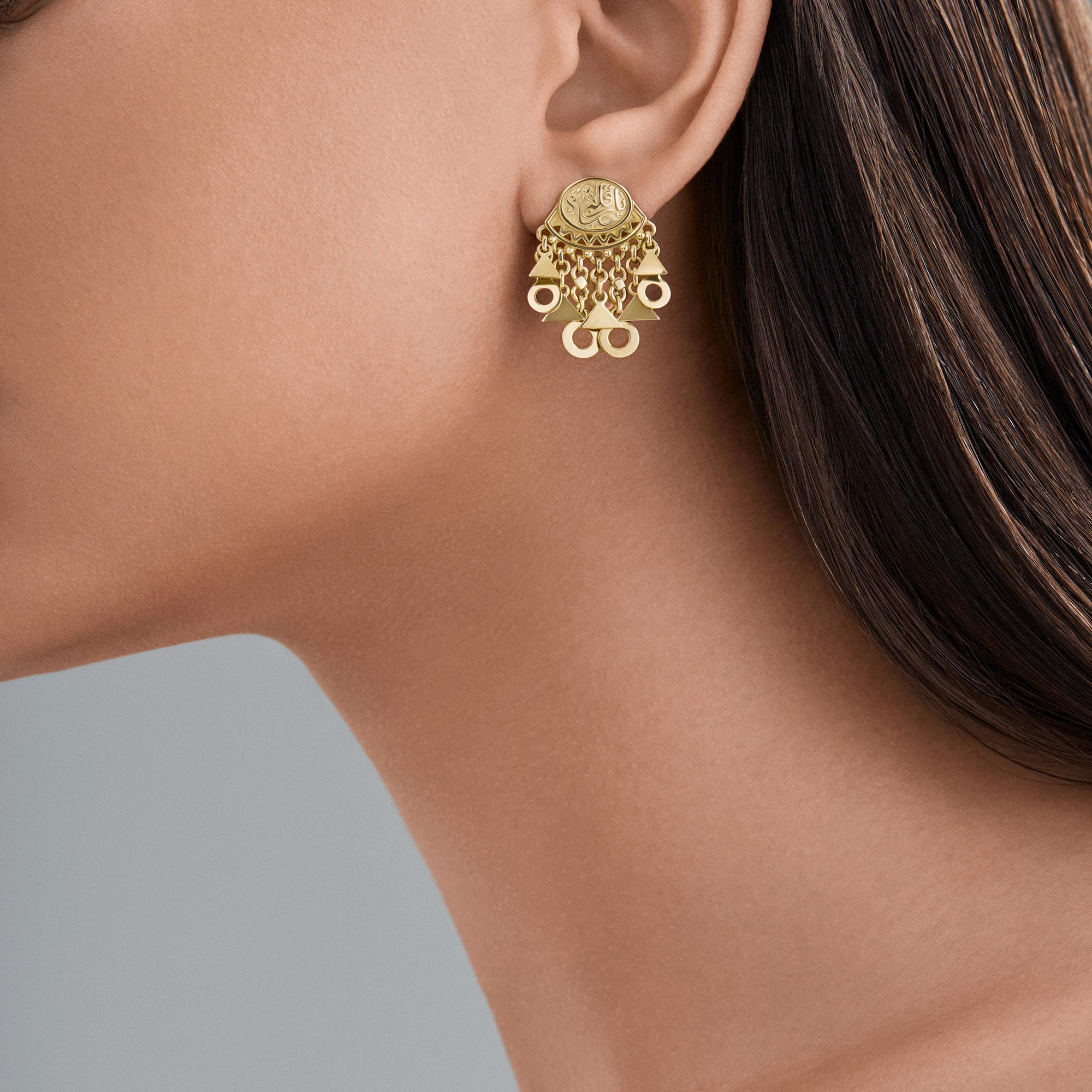 18 Karat Gold Earrings adorned with calligraphy and charms inspired by styles traditionally worn by women of the Egyptian countryside. Part of Azza Fahmy's Gypsy collection which takes inspiration from the nomadic Amazigh tribes people of Northern
