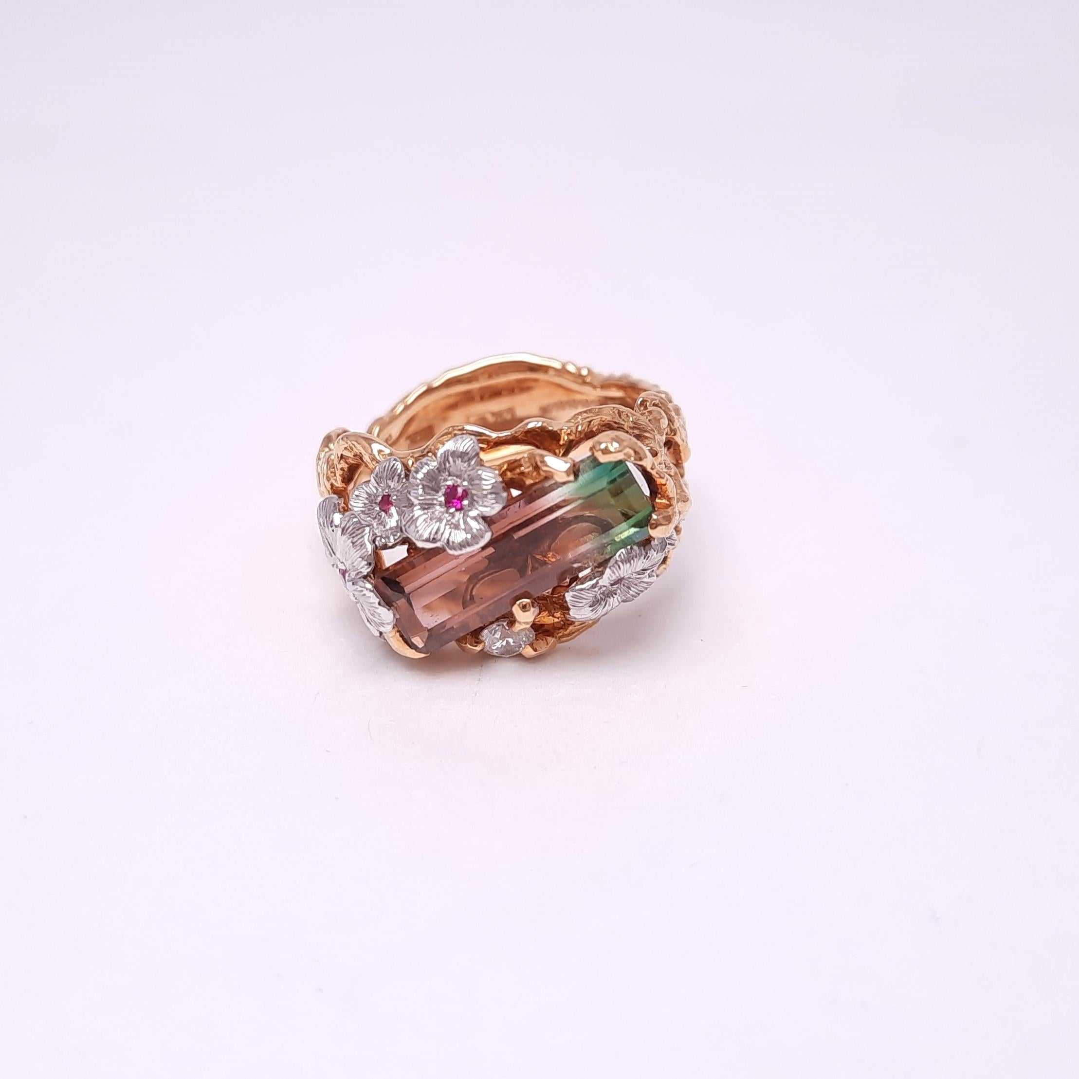 A unique watermelon color tourmaline is aesthetically designed in a tender floral style, celebrating the warm season.  The artistically engraved twig-like gold filigree and floral petals hold the tourmaline gently like a part of a natural scene.
The