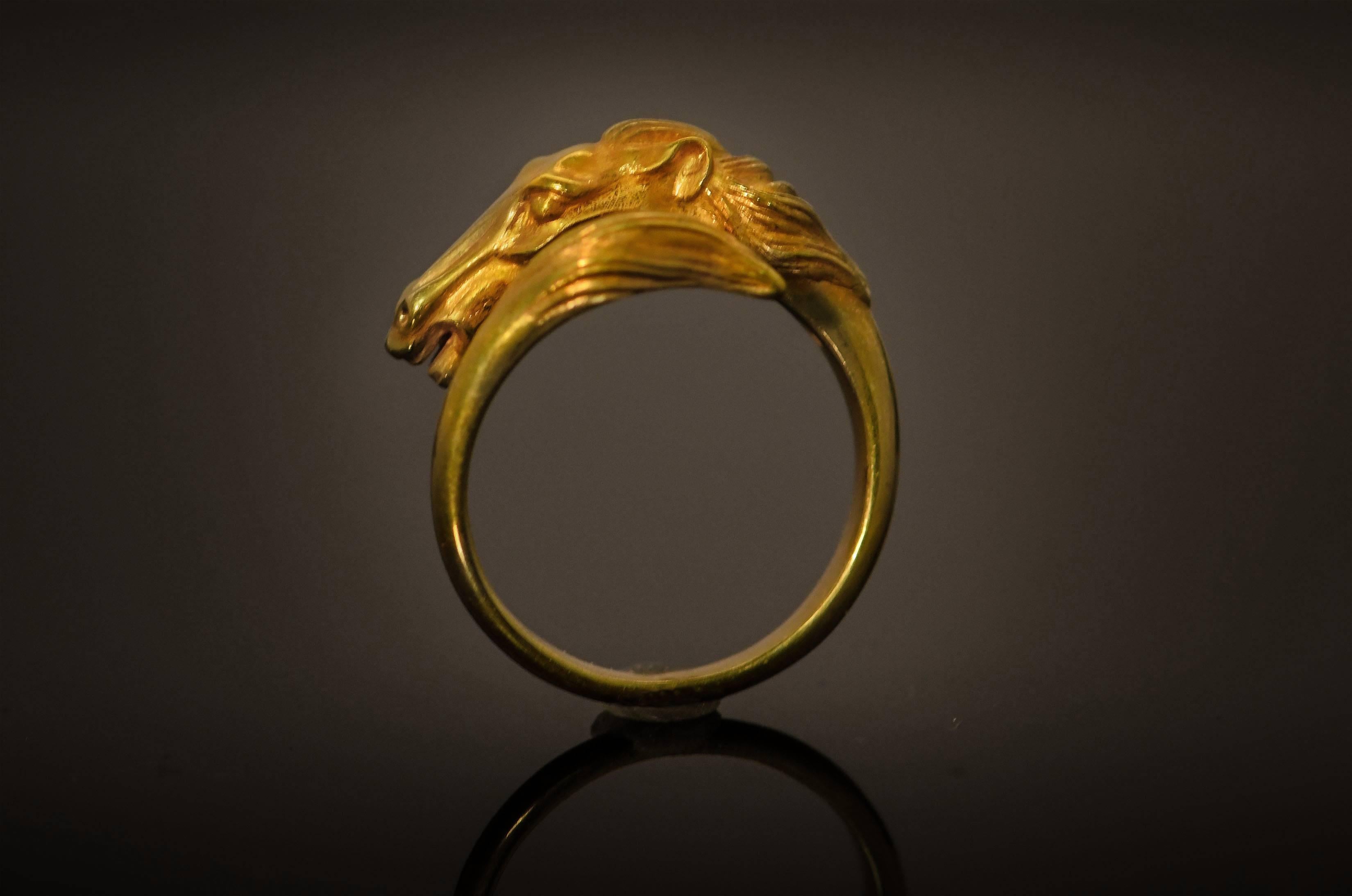 The horse shown on this beautiful ring is such a handsome specimen. His mane is streaming behind him in the wind as he races on. He is straining with the effort but seems to be enjoying it. The tail forms the other end of the crossover ring, the