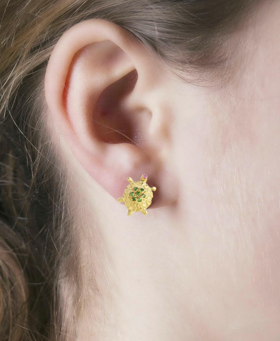 Rossella Ugolini Design collection, a pair of Little Turtles Stud Earrings handcrafted in 18 Karats Yellow Gold and adorned with a beautiful deep green tsavorites and pink tourmalines. Designed to be worn with joy, the colors of the earrings are