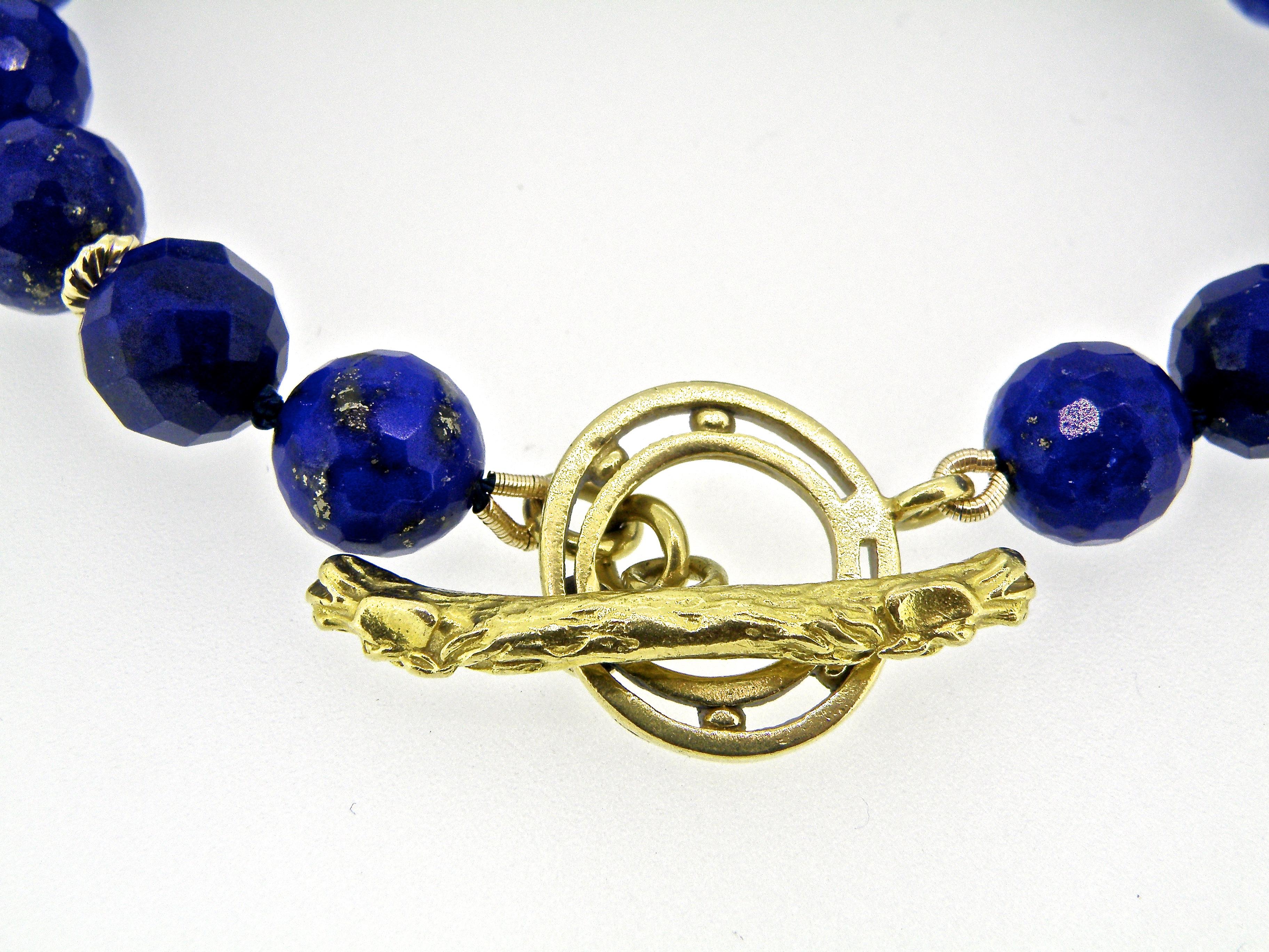 8 mm Facetted lapis lazuli bracelet with gold rondells and 18 karat custom horse toggle bracelet