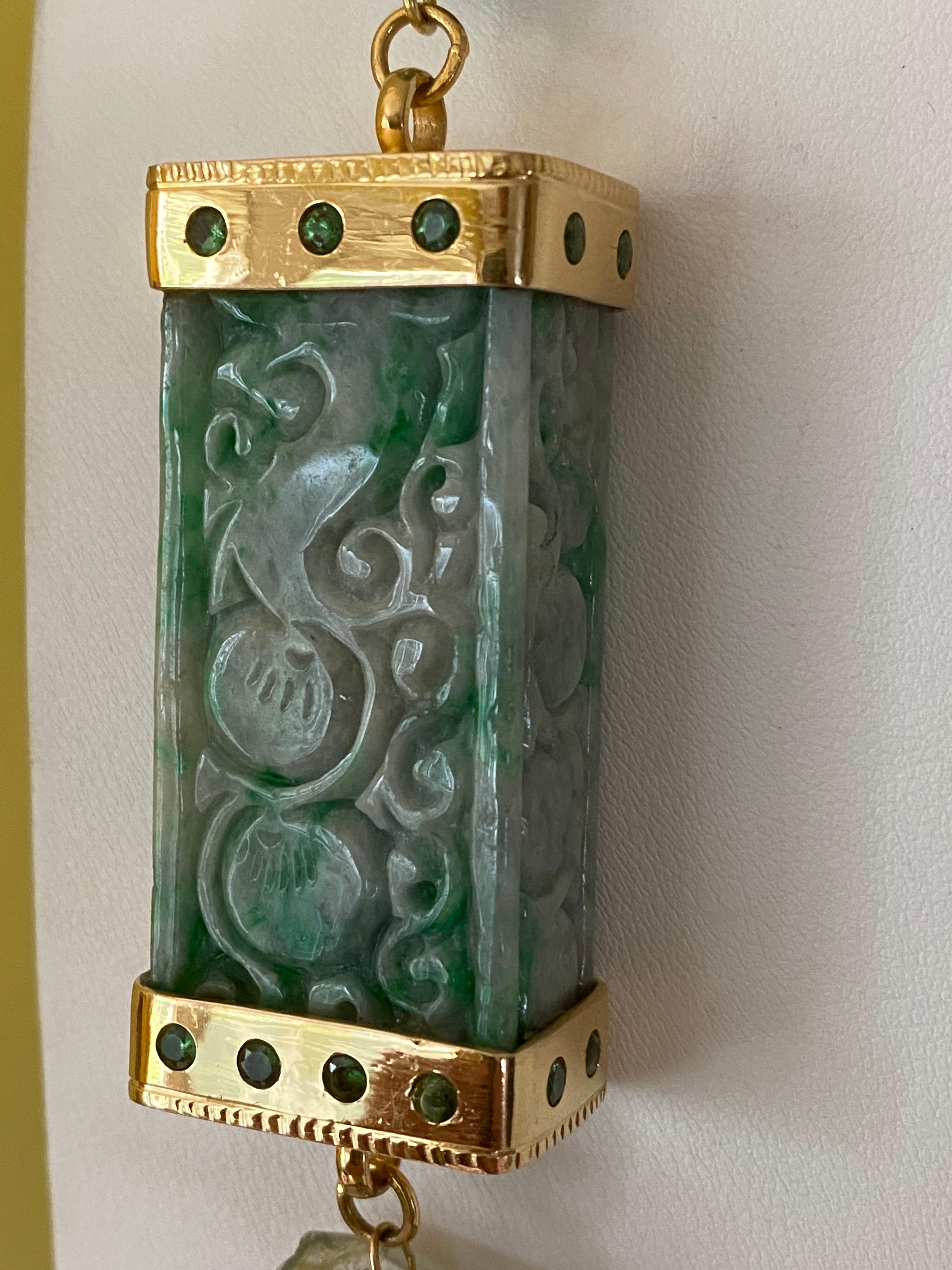 Jane Magon Collections Statement Necklace from the East Meets West Collections features carved Burmese Jade Rectangular Cylinders (one capped in 18 Karat Yellow Gold that is set with Tsavorite Garnets. Another focal point is a flow knot in light