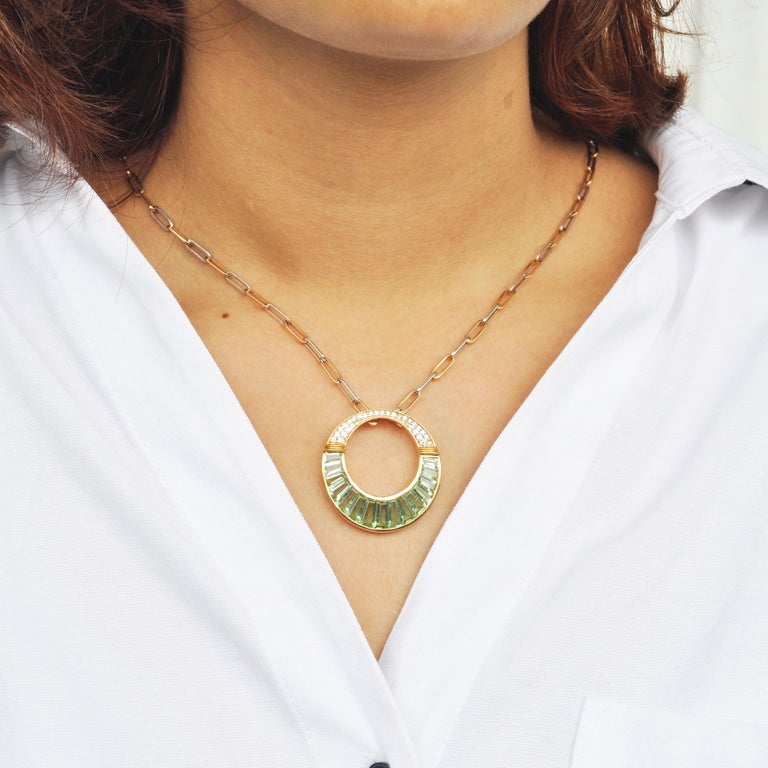 Inspired by the necklace worn by Cleopatra in the Egyptian Era, this circular pendant made in 18K gold gives it a contemporary make-over. The pastel shades of 6.03 carats of mint green tourmaline captures the mood of tranquillity ! Meticulous