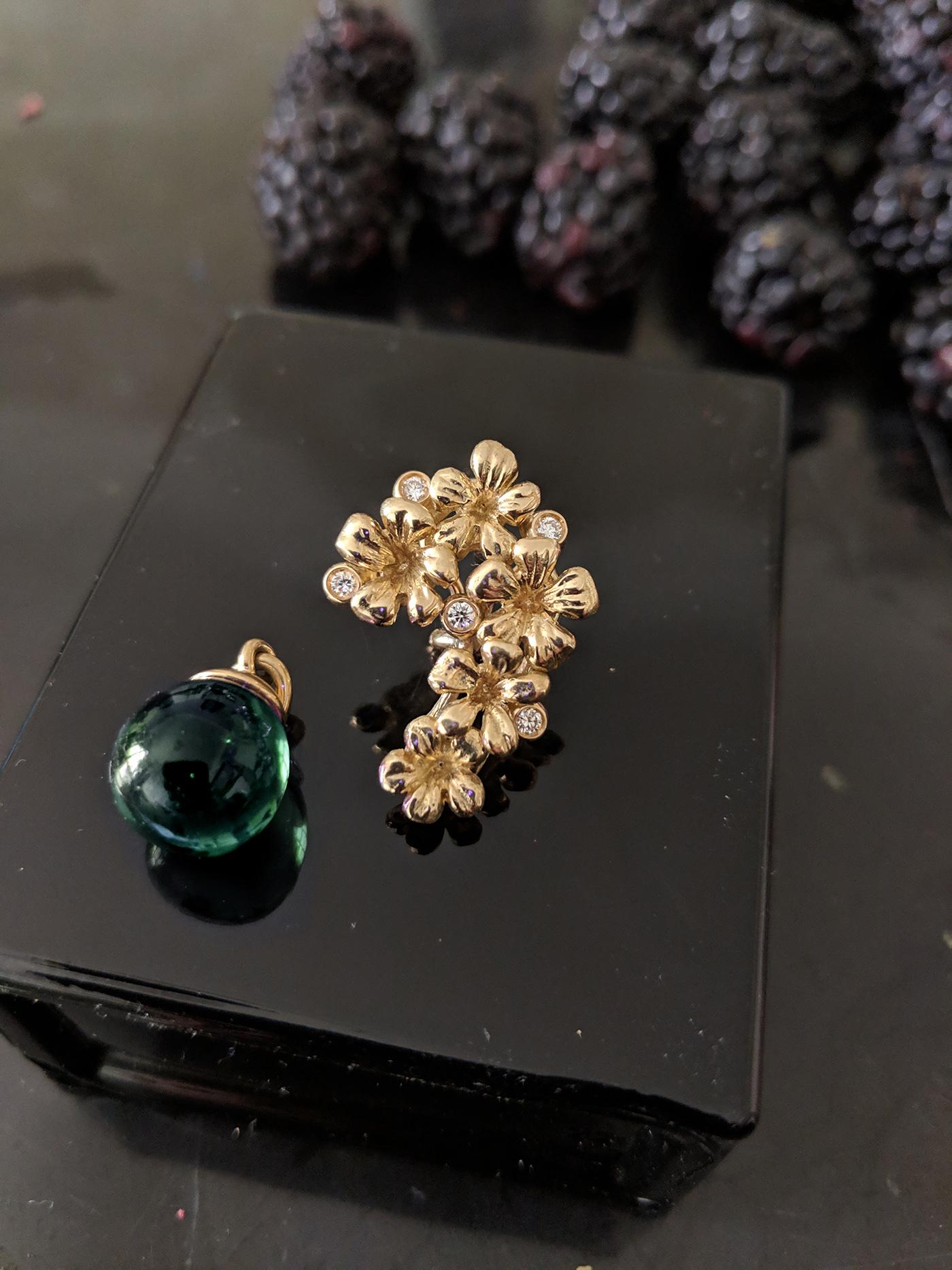 18 karat yellow gold Plum Blossom brooch encrusted with 5 round diamonds and a cabochon green tourmaline drop. This contemporary jewellery collection has been featured in Vogue UA review. We use top natural diamonds VS, F-G, and work with a German