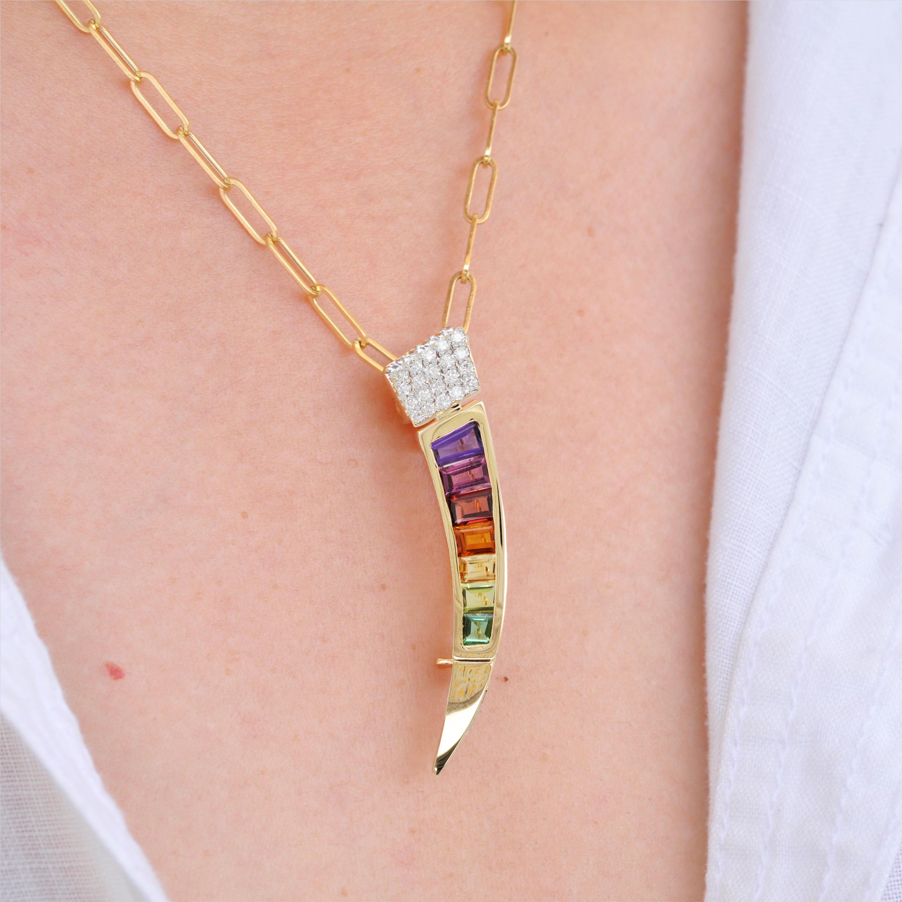 18 karat gold Muticolor Rainbow tapered baguette diamond pendant brooch

This edgy pendant brooch is a striking and contemporary piece of jewelry that combines vibrant multicolored gemstones with the elegance of 18 karat gold. The design features