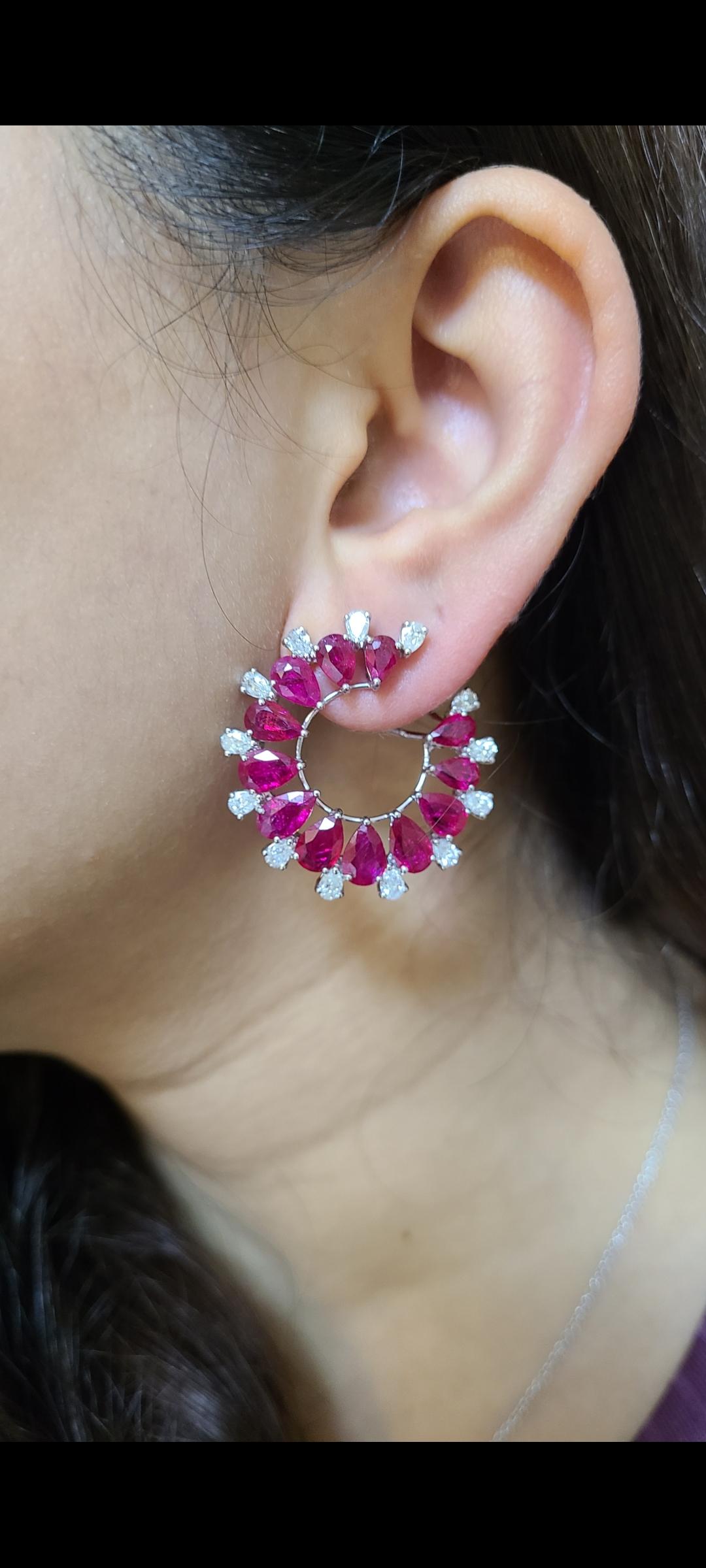 A gorgeous and very wearable pair of Ruby Hoop Earrings set in 18K Gold & Diamonds. The weight of the Rubies is 14.76 carats. The Rubies are completely natural, without any treatment and originate from Mozambique. The combined weight of the Diamonds