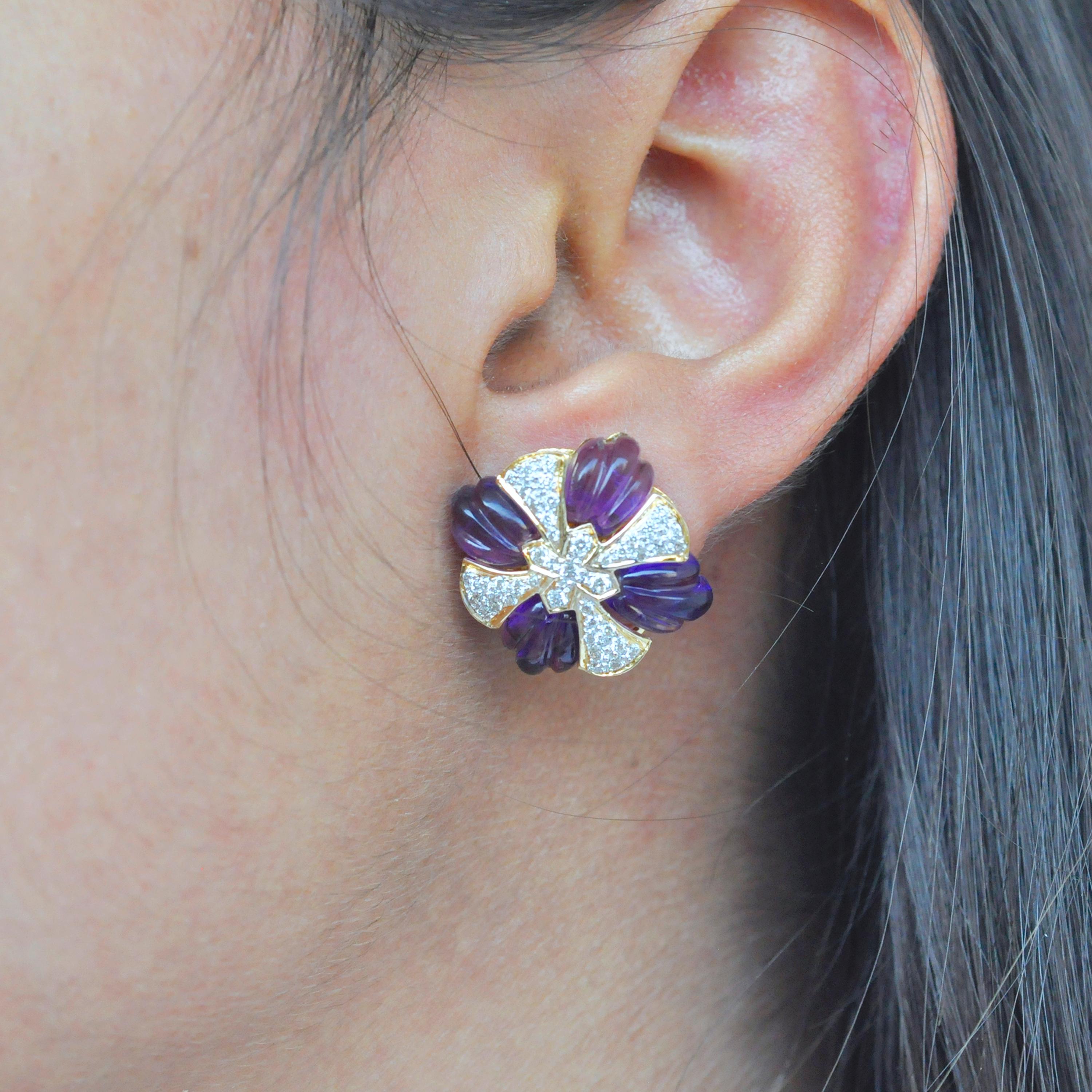 A beautiful classic yet one-of-a-kind amethyst carving stud earrings is a chic piece to have in your jewelry closet. The earrings uses 18 karat yellow gold with diamonds and amethyst carving precisely set in the shape of a wheel complimented by pave