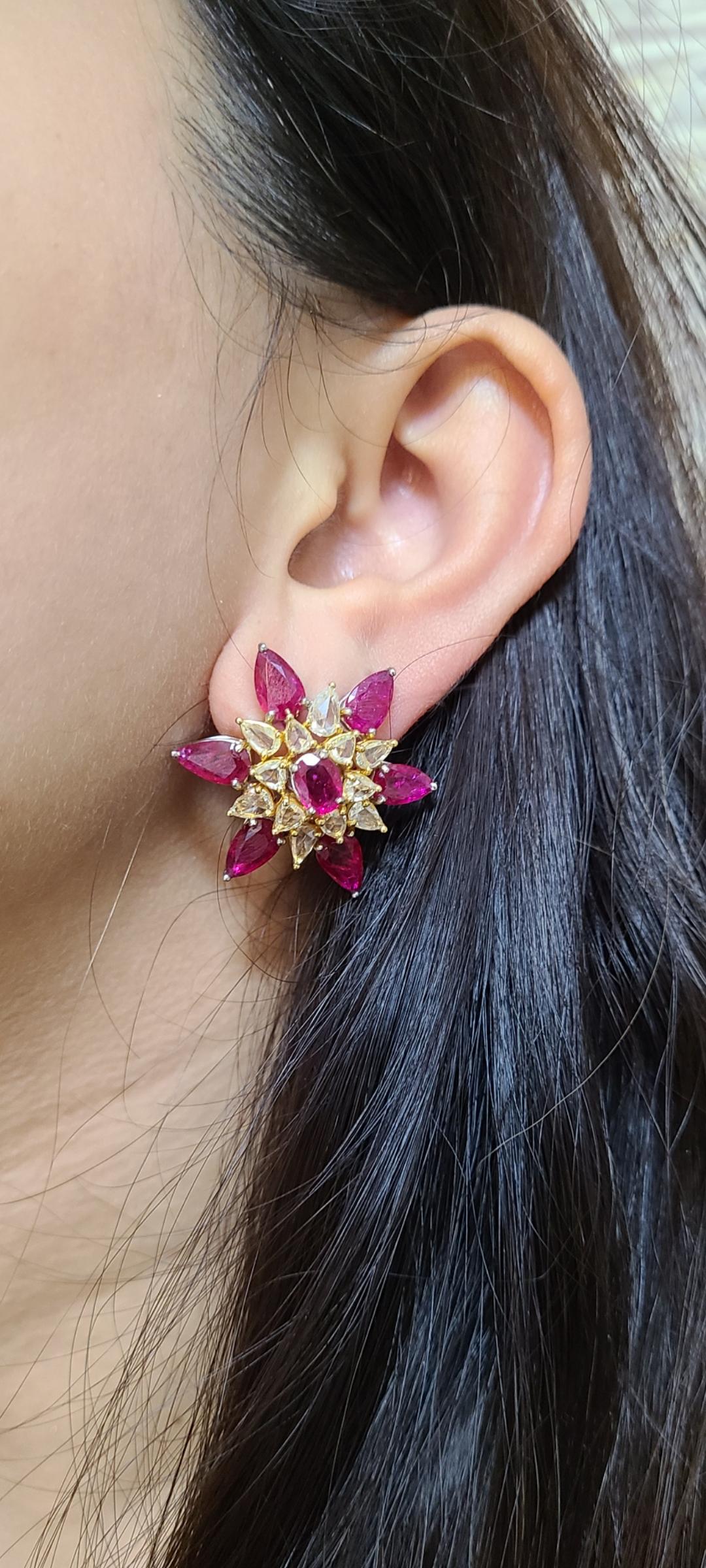 beautiful flower pattern design studs set in white and yellow gold , rubys are unheat from mozambique (12.85 carats) and rosecut diamonds are from africa (3.25 carats) . these are exclusive earrings , designed carefully and made beautifully with