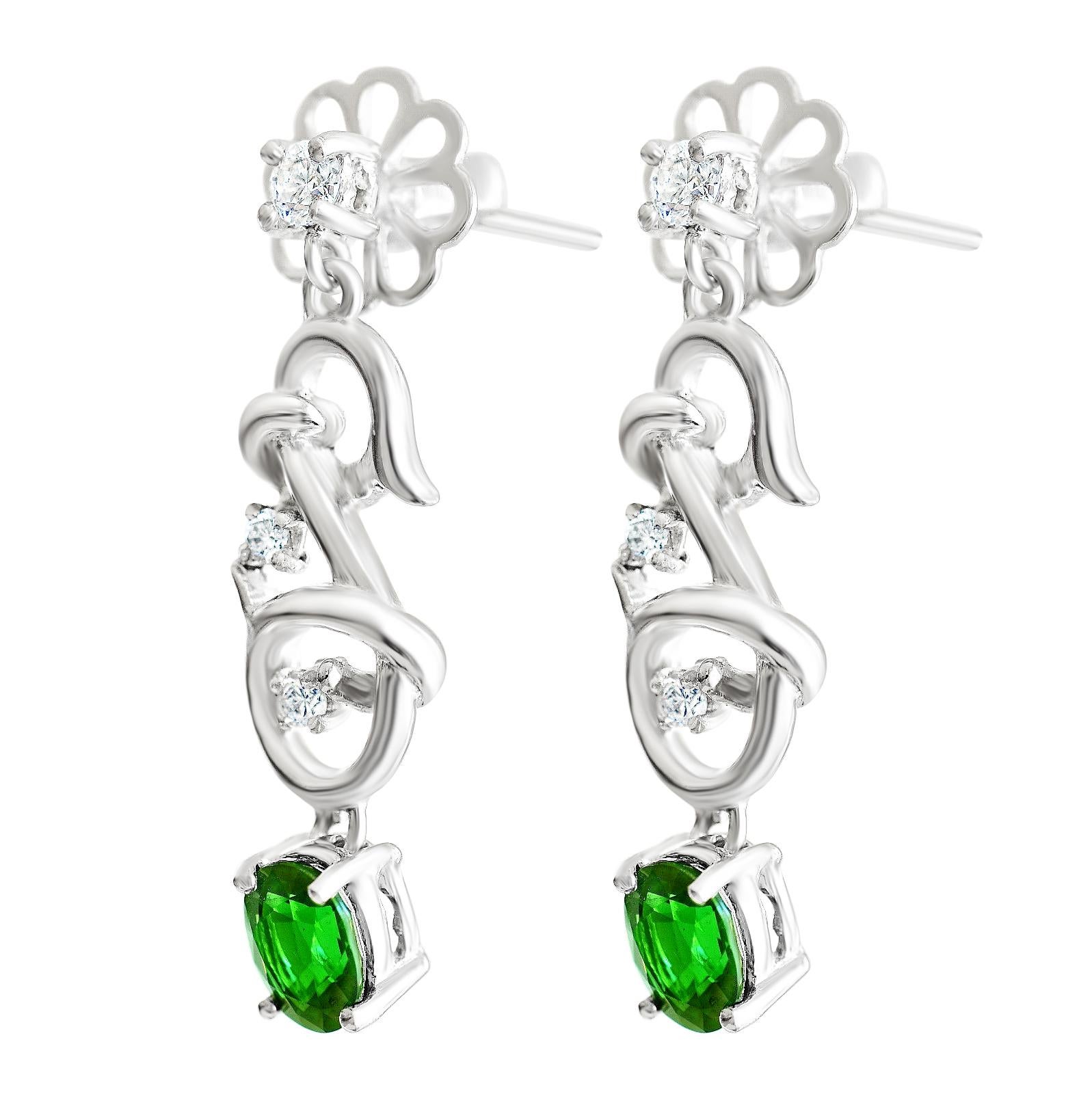 Handmade Tsavorite Garnet & diamond earrings set in 18 carat white gold drops.

Tsavorite Garnets are quite rare with small deposits being found only in Kenya, Madagascar, Pakistan & Antarctica.

They only received prominence after they were