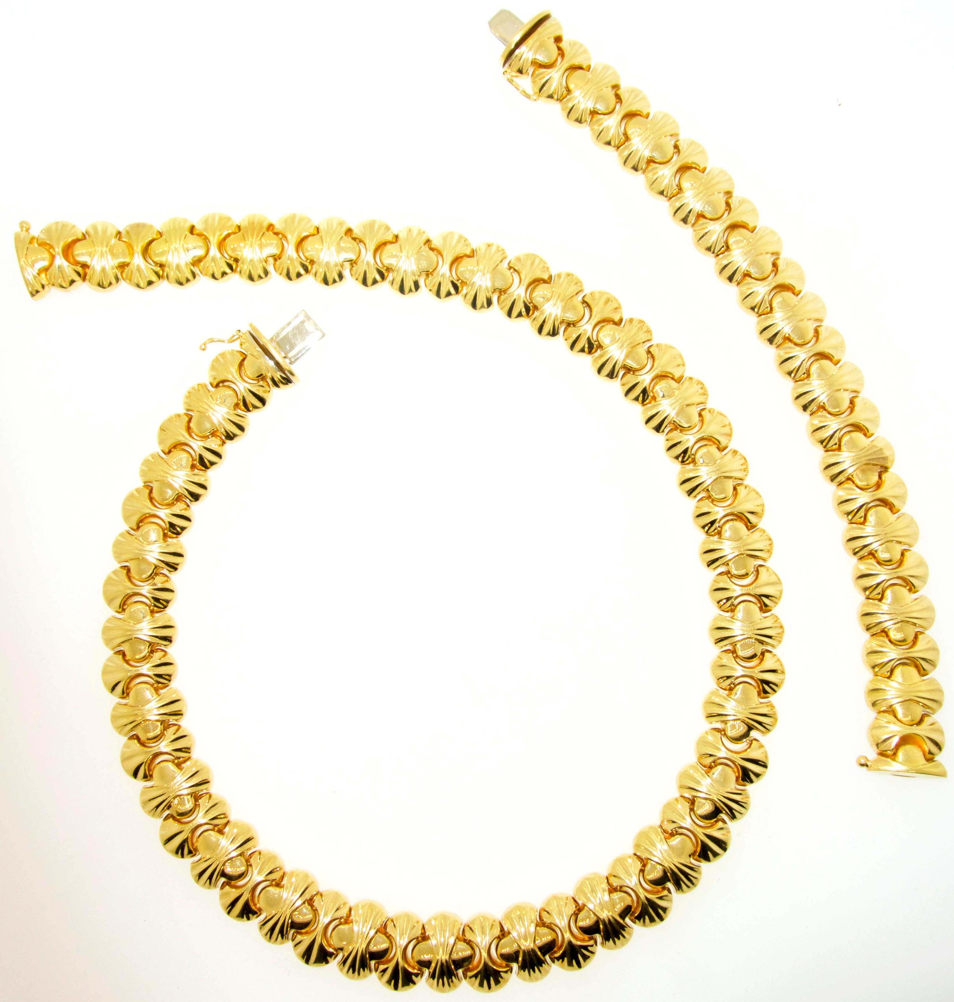 18K gold necklace choker length and a matching 7 inch bracelet.  The set weighs 115.71 grams.