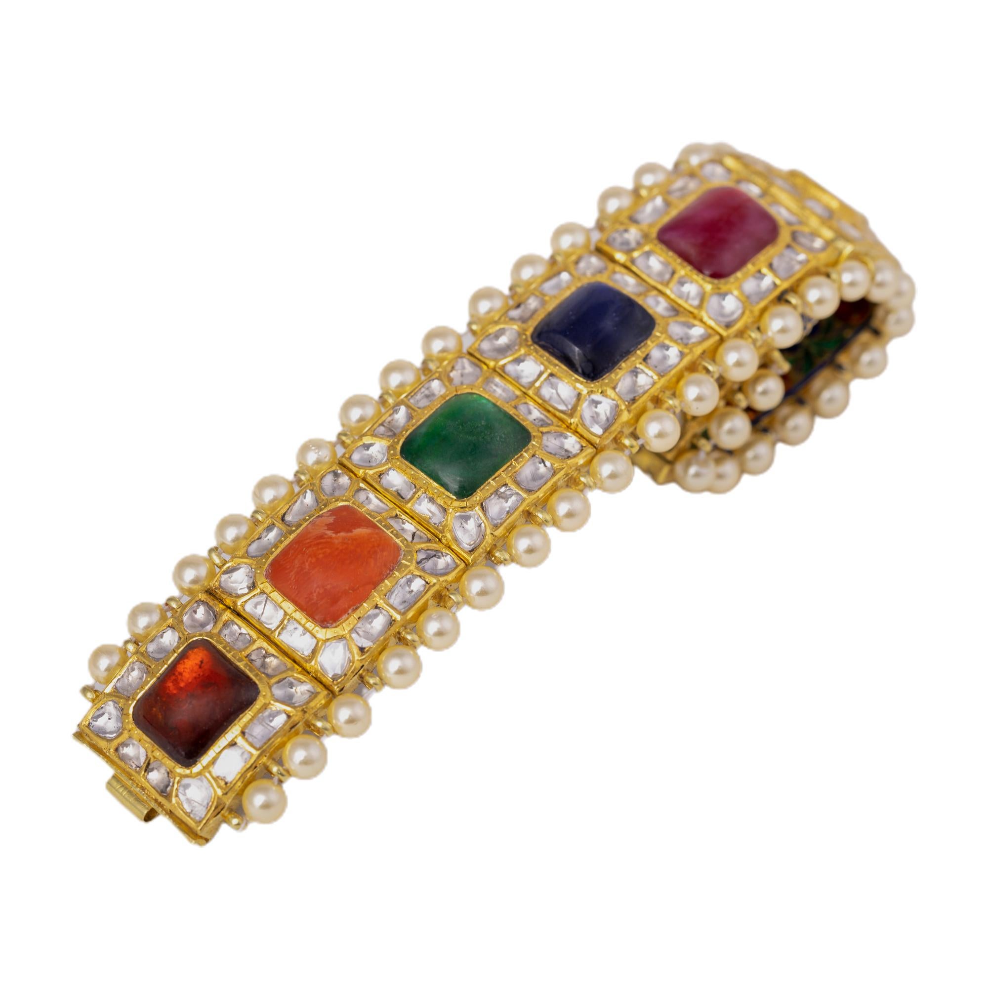 18 Karat Gold Nine Precious Gems Statement Handcrafted Bracelet with Enamel Work

This impeccable antiquated Mughal era style hand-crafted Navratan (nine) gems and polki diamond cluster bracelet is sensational. Navratnas of the nine gemstones
