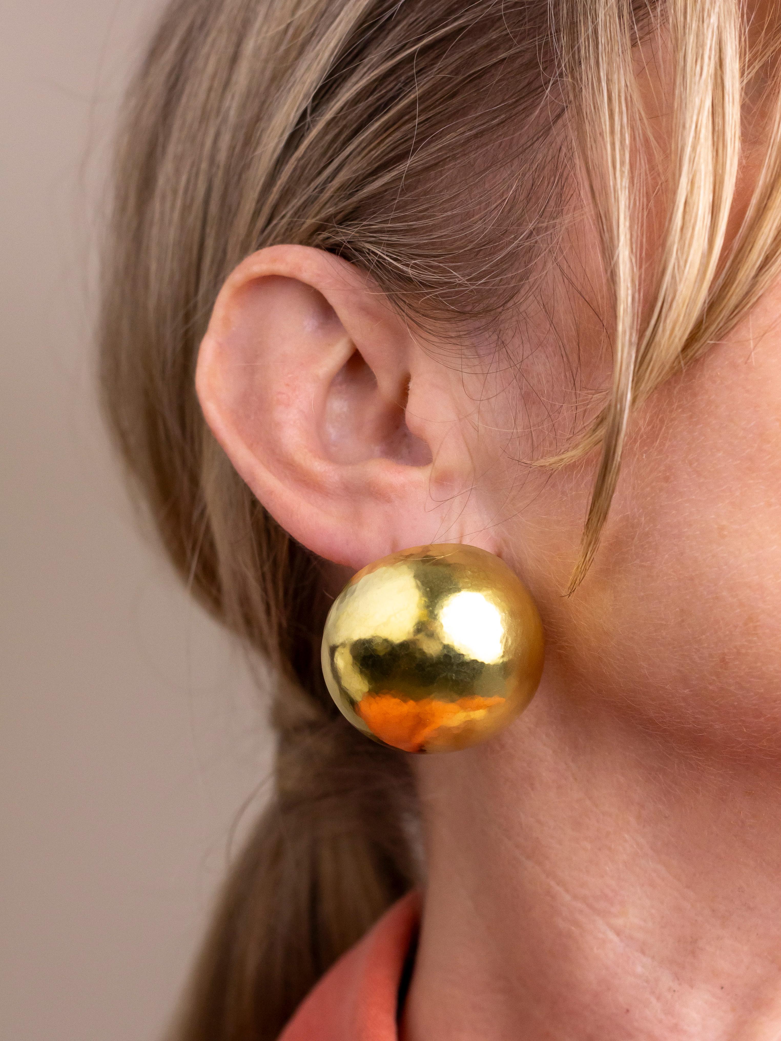 This pair of large hammered gold earrings were made by Canadian jeweller, Karl Stittgen. The 'golf ball' style earrings are entirely hand hammered which gives them the most wonderful matte texture and sheen which is hard to translate in photographs.