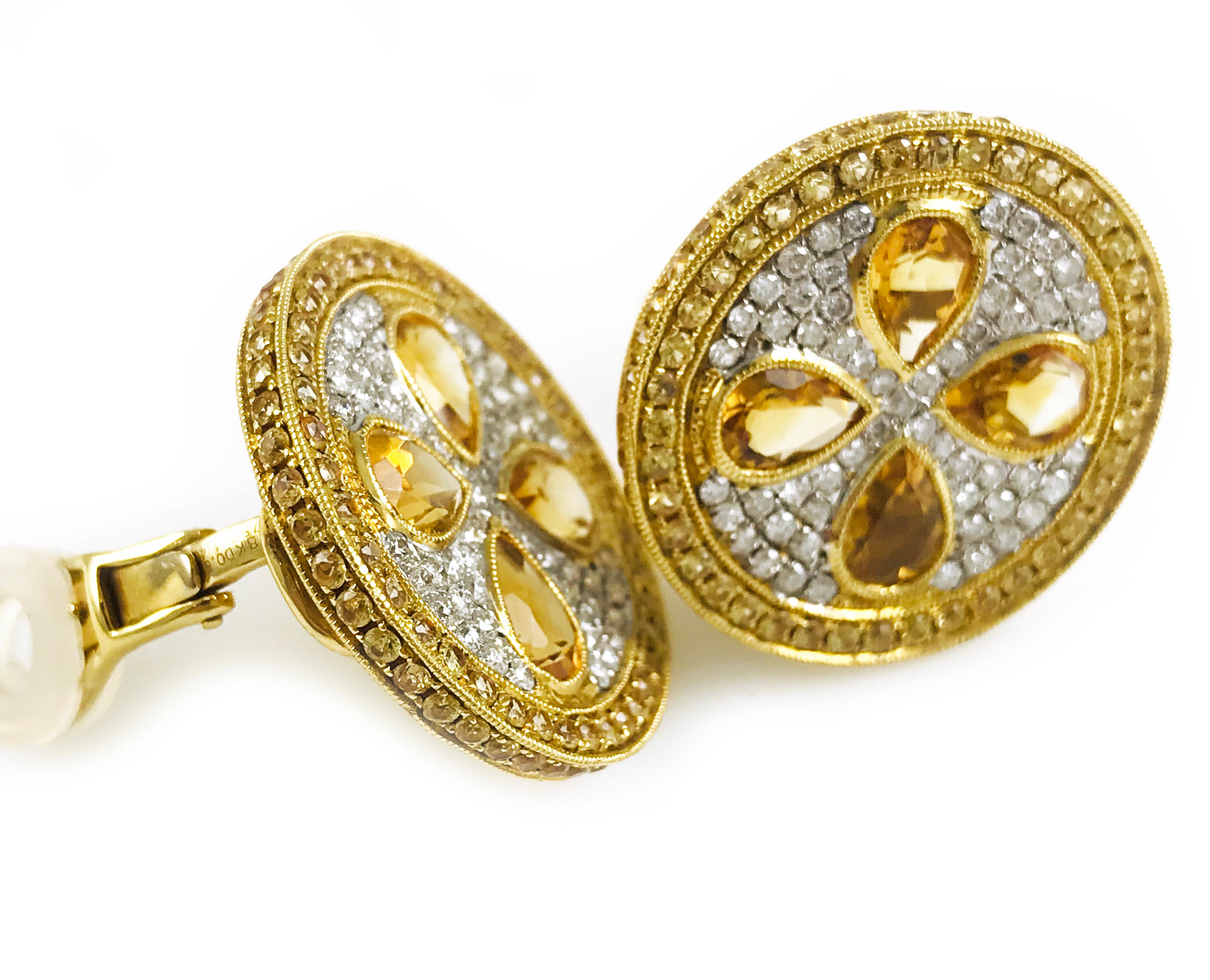 18 Karat Gold Pavé Yellow pear-shaped Citrine, yellow natural Sapphire and Diamond Earrings. Four stunning pear-shape bezel-set yellow Citrines adorn these earrings with round-cut bead-set yellow natural sapphires on the outer circle and around the