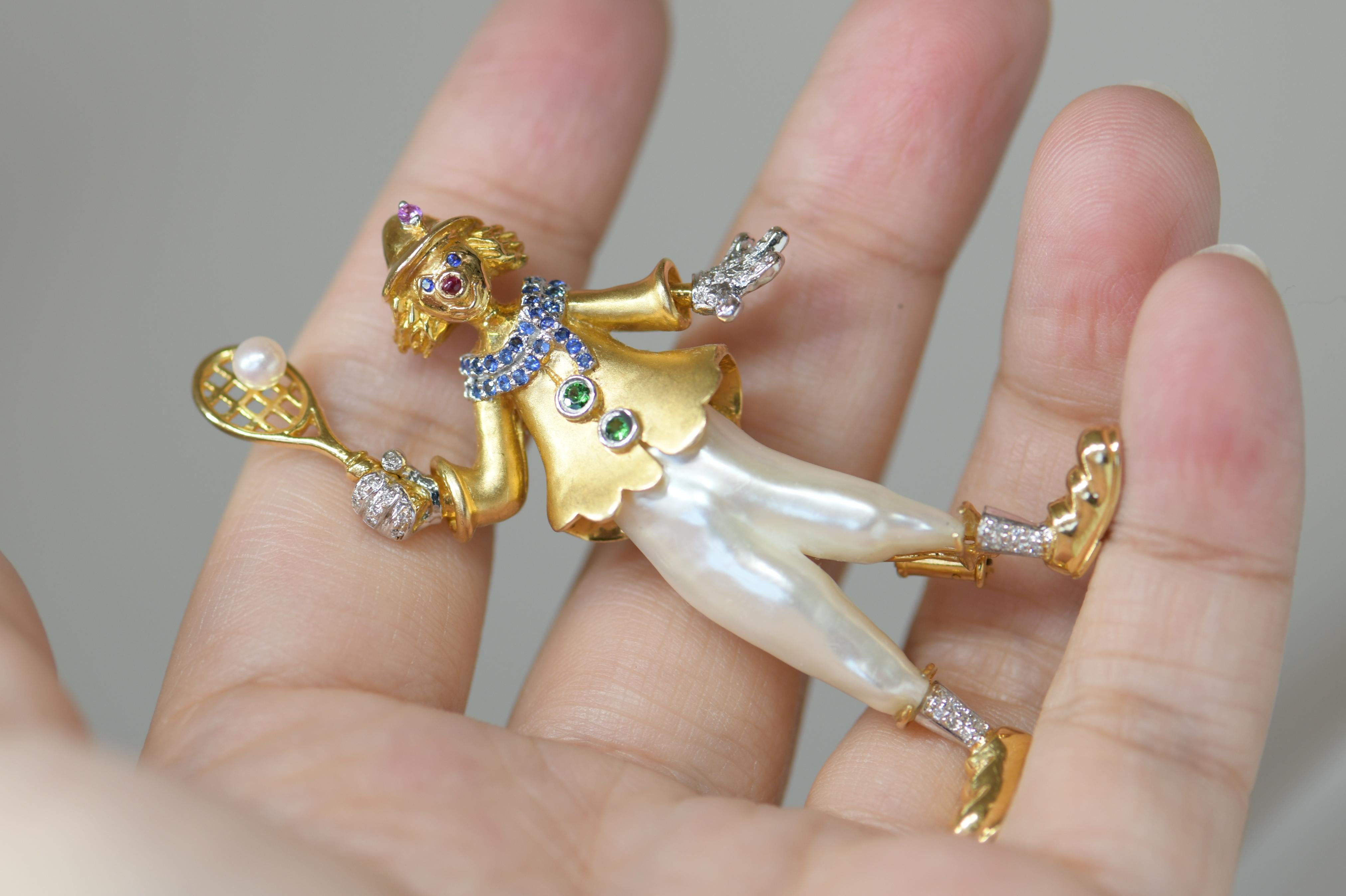 Featuring a Unique Vintage Multi-gem Clown Pin Pendant, handcrafted in 18k Yellow Gold; the clown is wearing Cultured Pearl Pants and diamonds on the gold boots, hands; accented by twinkling sapphire and ruby. Marked: 750; This delightful piece