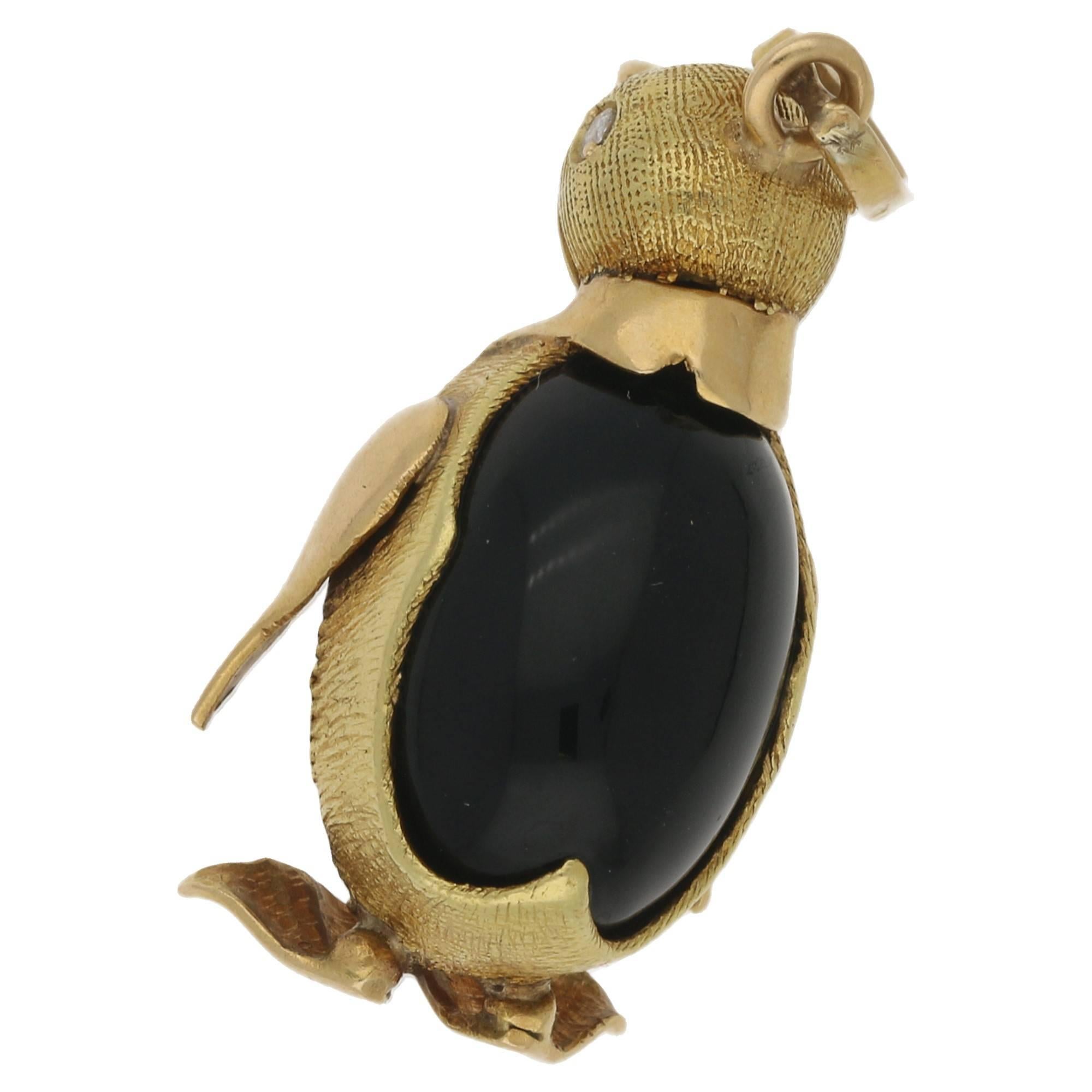 A very cute rotund penguin charm, with a cabochon gem set body. Detailed with diamond eyes, in rich 18k yellow gold. The penguin measures 35mm to the top of the bale, width 18mm. The gold is beautifully detailed, with a brushed effect. This would