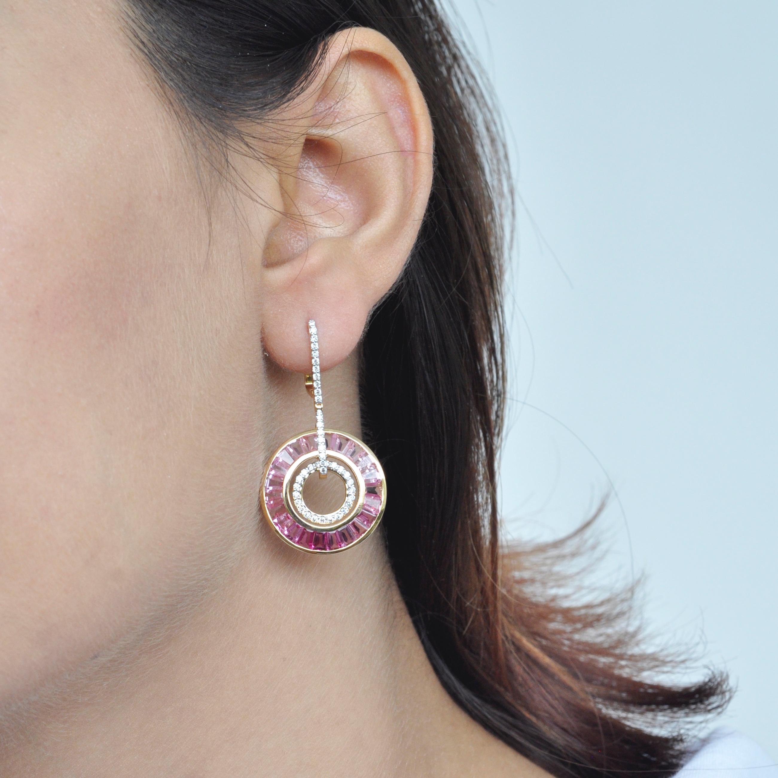 Art deco style, color and culture all come together to inspire this delicate 18 karat gold pink tourmaline baguette diamond dangle art deco pair of circle earrings, where dégradé (gradient) hues of pink tourmaline exudes feminism while dictating the