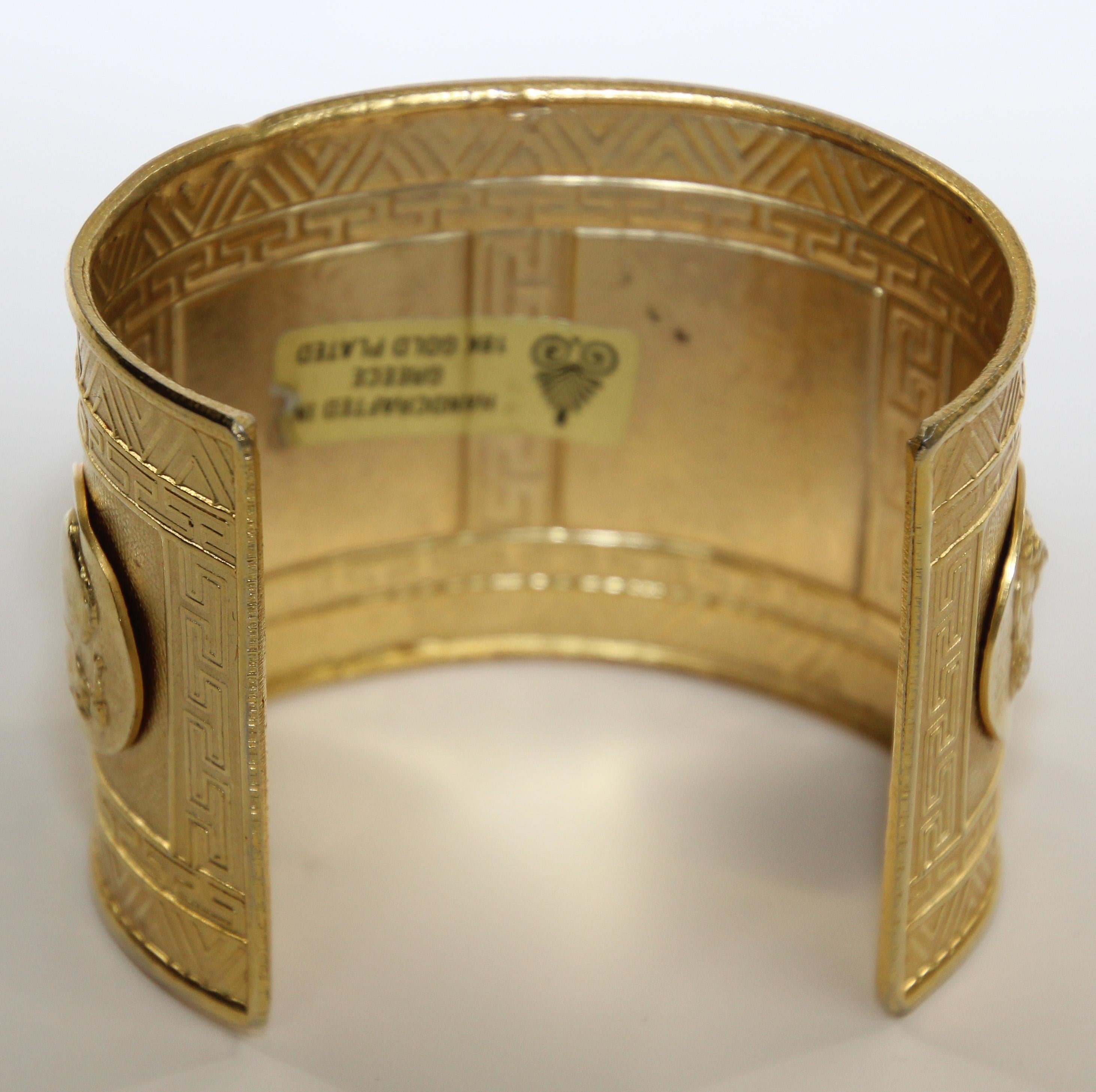 18 karat gold plate wide Greek cuff bracelet in the style of ancient Rome thick folded borders.
Women Men Cuff bracelet with figures of Caesars applied in medallions and geometric Greek designs.
Dress your wrist in this glowing statement maker.