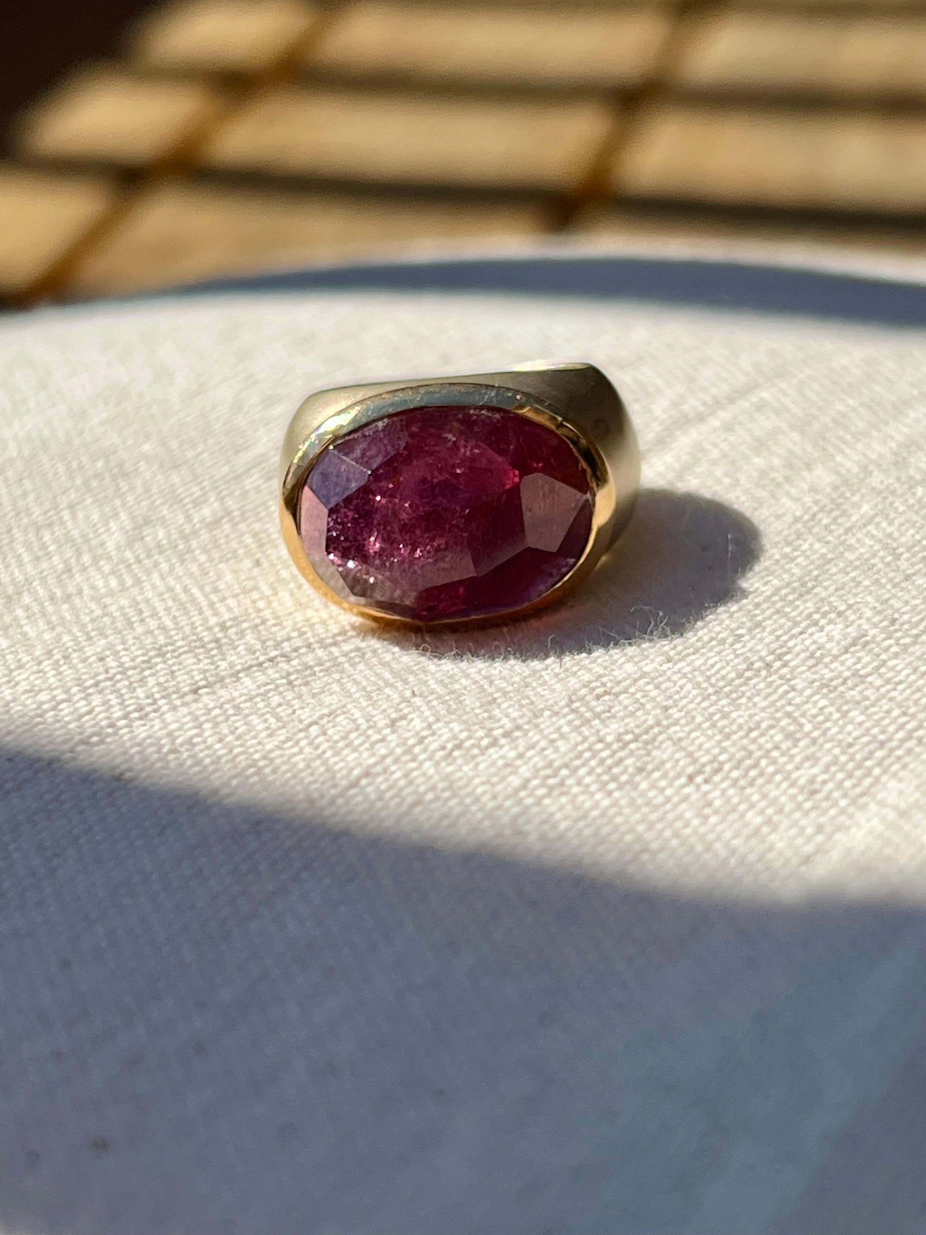One 18 Karat Yellow gold (stamped 750 Pomellato) ring bezel set with one 18x13mm pink Tourmaline stone.  The ring is a finger size 6.5.
