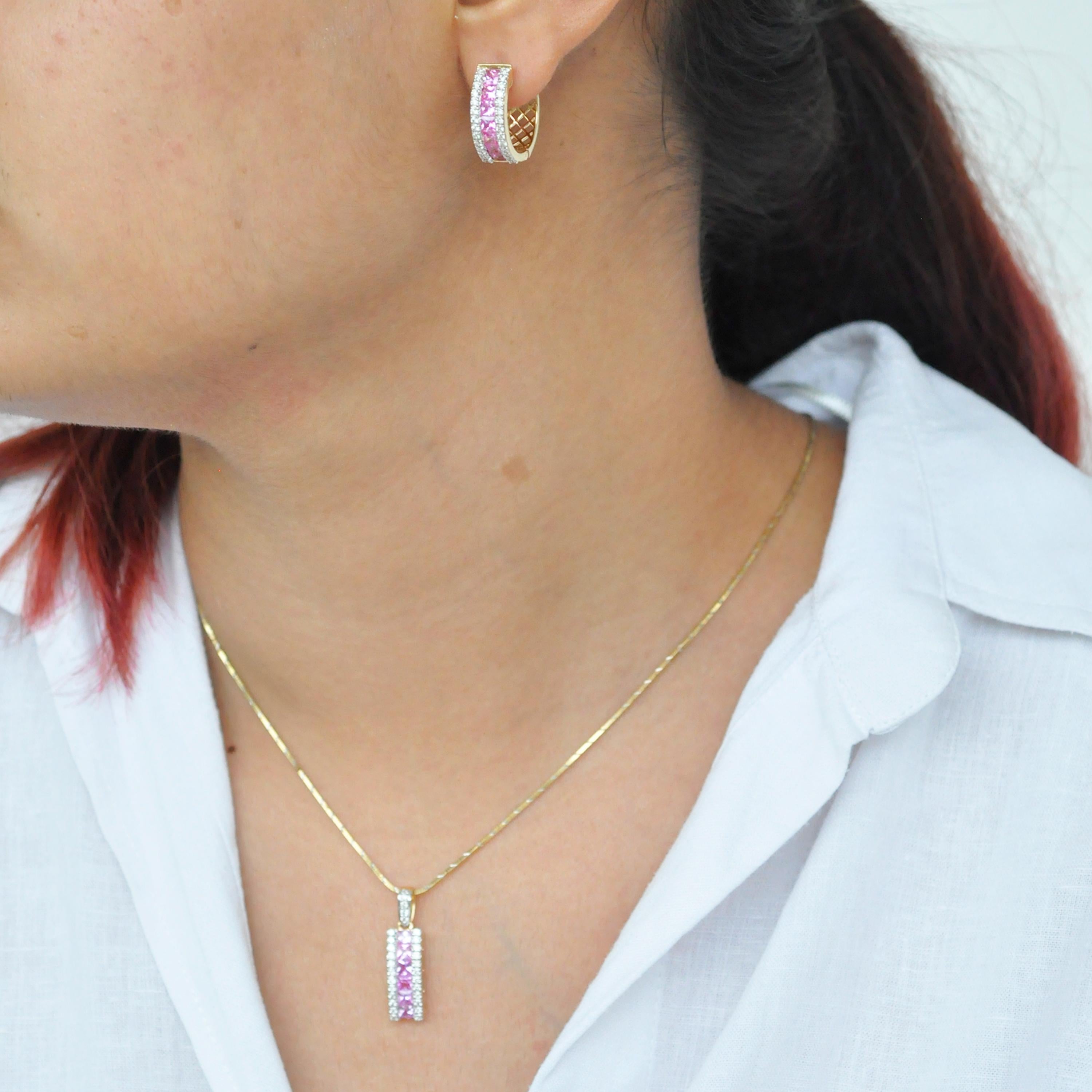 18 karat gold princess cut pink sapphire diamond pendant hoop earrings set.

This beautiful linear set of pendant and hoop earrings with lustrous pink sapphires is extremely spectacular. Elegance and chic in one, this set features high quality clean