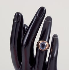 18 karat gold ring adorned with light blue semi-precious stones.