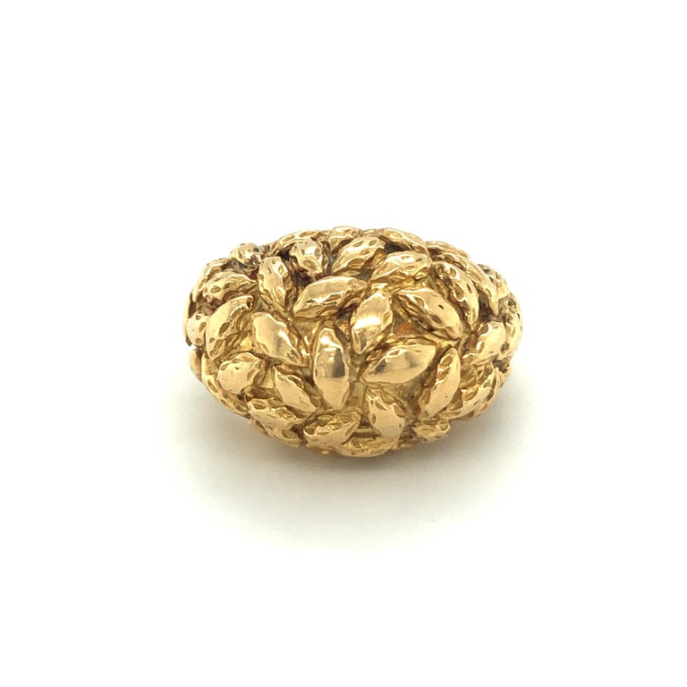18 karat yellow gold ring by Van Cleef & Arpels, signed and numbered. Classic Van Cleef & Arpels design and typically textured surface from the 1960s.
The ring shows minor signs of wear, the textured surface is slightly smoothed on the ring head. It