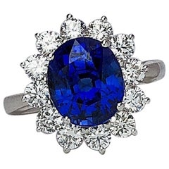 18 Karat Gold Ring with 5.12 Carat Oval Blue Sapphire with 1.27 Carat Diamonds