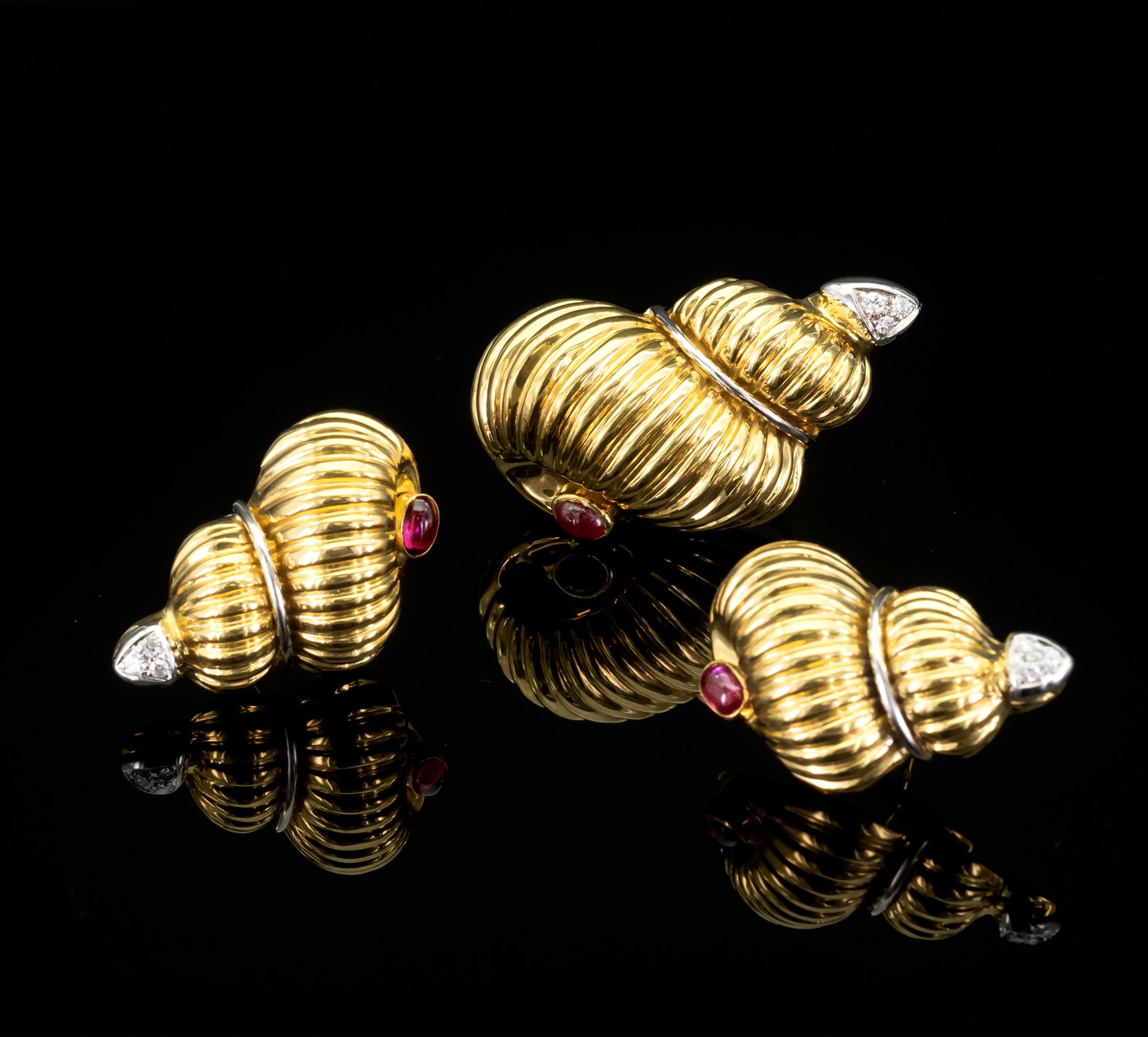 Elegant  shell shaped earring and brooch set . Made in 18 karat ribbed yellow gold . Each shell is set with lively ruby cabochon on one side while the top of it is adorned with diamonds set on white gold. 
Details:
Rubies: 1.51 carat
Diamonds: 0.26