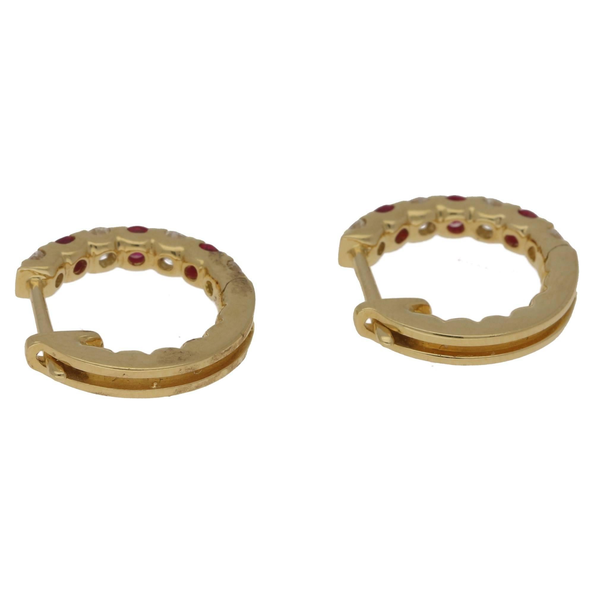 Intense ruby and diamond hoop earrings. The rich rubies total 0.35ct's and the diamonds 0.37ct's, G/H colour and VS clarity. In fully hallmarked 18k gold, the earrings are also detailed with the stone weights. On simple to use click shut fittings.