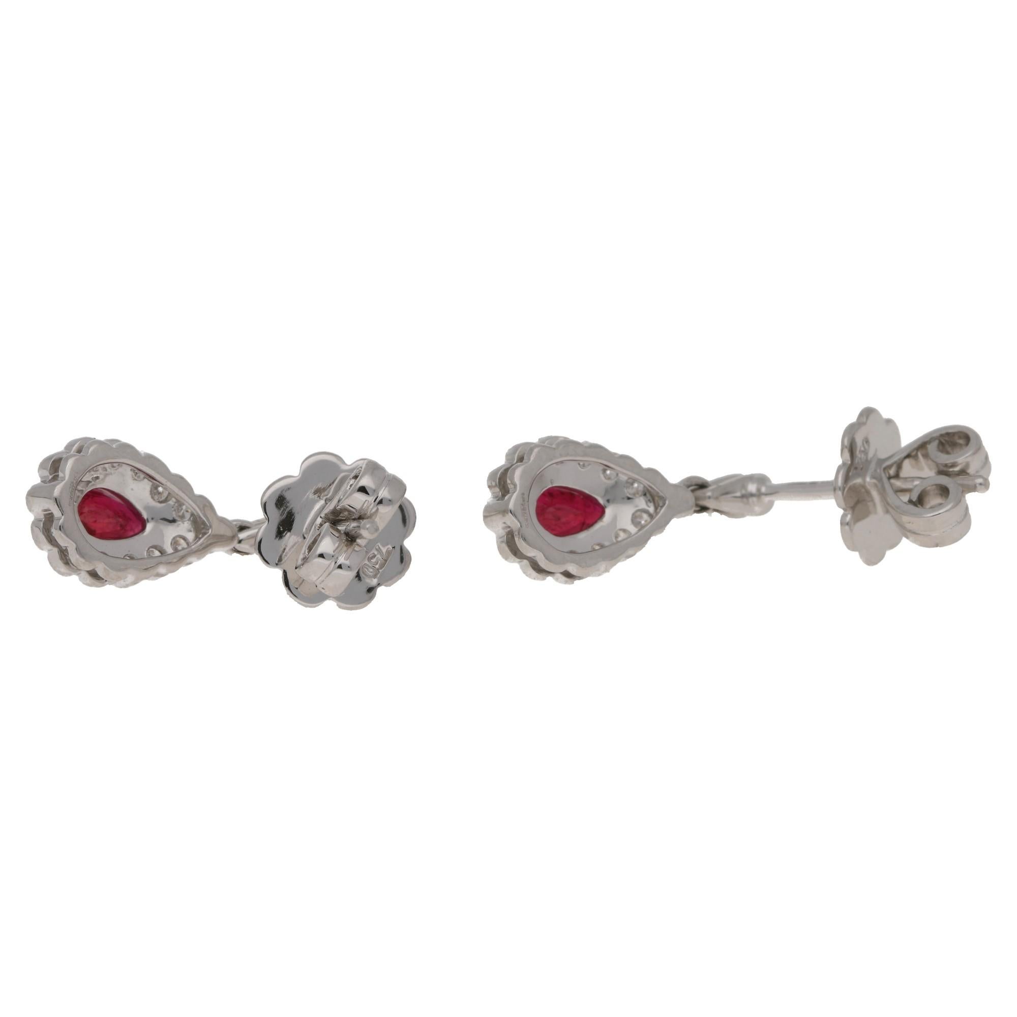 A classic pair of 18k white gold ruby and diamond drop earrings. The rubies total 0.92cts and the diamonds 0.43, set in 18k white gold. On a classic post and butterfly fitting. The earrings measure 18mm by 8mm approximately.