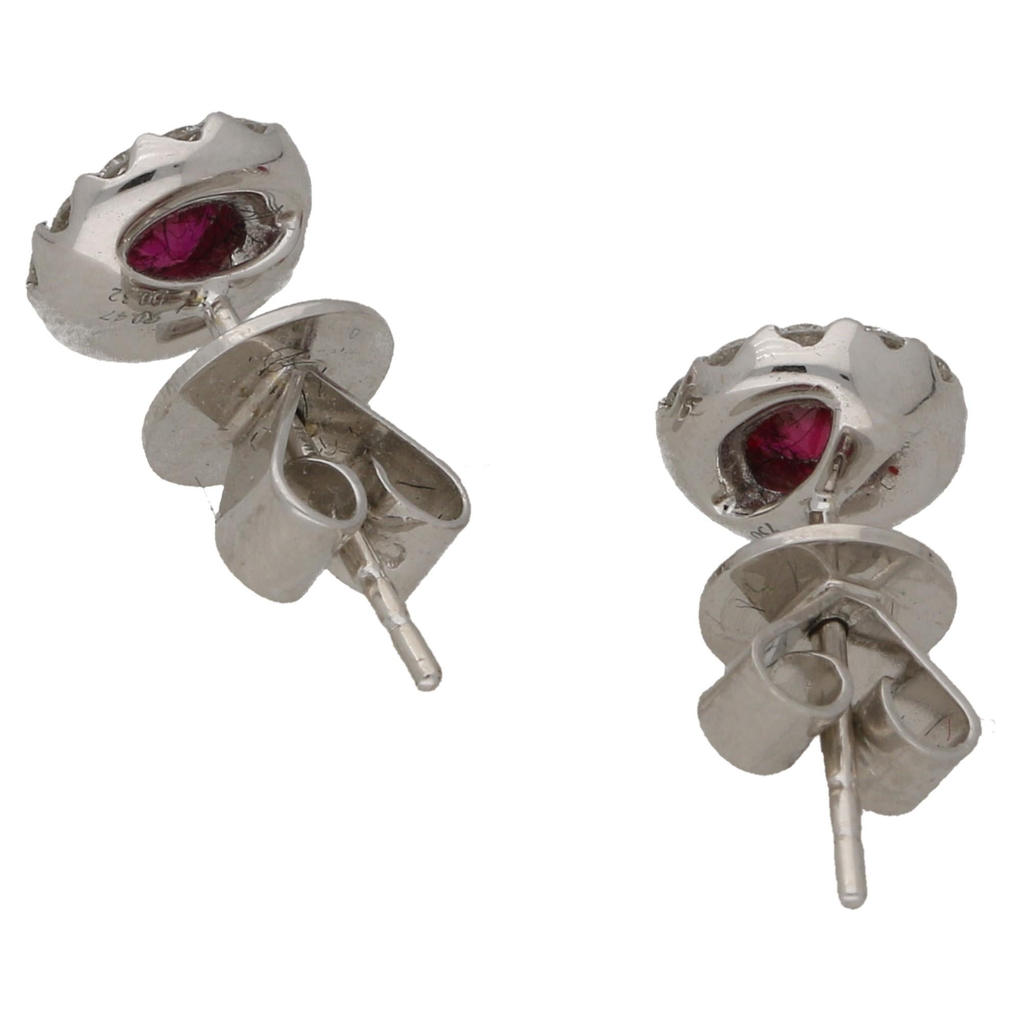 A pair of ruby and diamond cluster studs in hallmarked 18ct white gold. Ruby weight is approximately 0.47 carats and the diamond is approximately 0.32 carats total, G/H colour VS clarity. These are fitted with secure butterfly fittings.