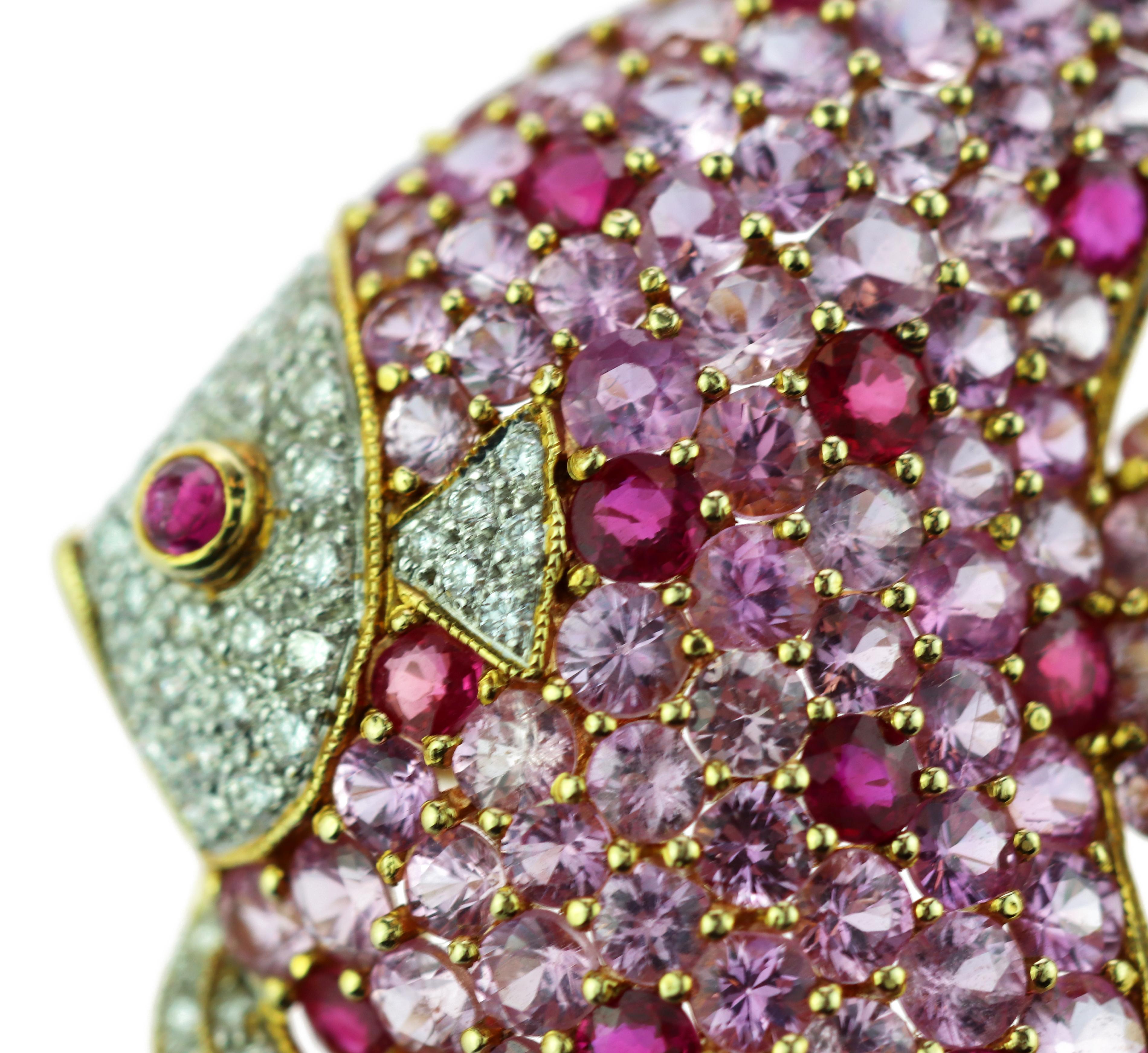 Grandiose and unique brooch modeled in the shape of a pink fish and embellished with pavé of sapphires, diamonds and a rubies.

This brooch is inspired by the tale of The Fisherman and the Fish. The tale is about a fisherman who manages to catch a