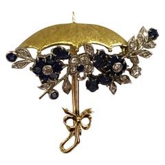 Regenschirmbrosche aus 18 Karat Gold mit Saphiren und Diamanten