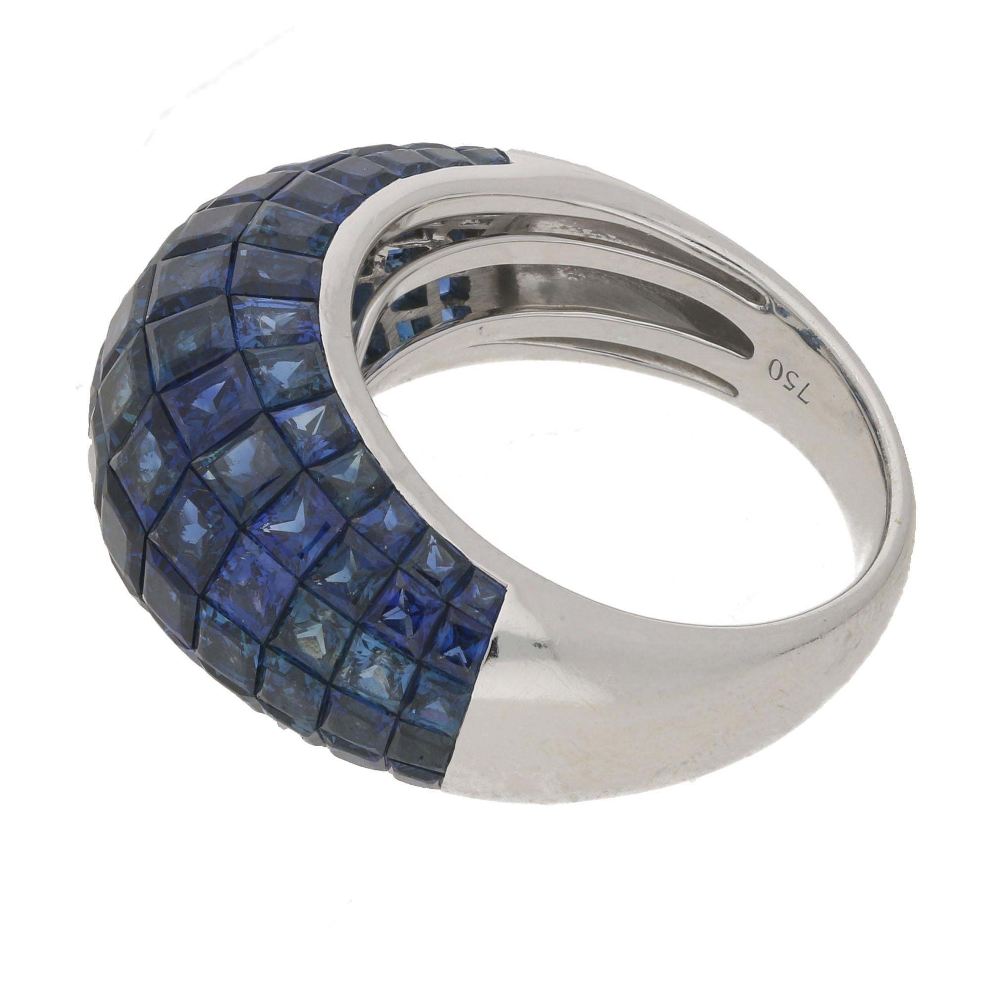 An amazing invisibly set sapphire bombe ring. Individually the square shaped sapphires are of exquisite quality and are French cut for maximum sparkle. The16.69cts of sapphires are set in 6 rows of graduated sizes forming a bombe style of ring, You