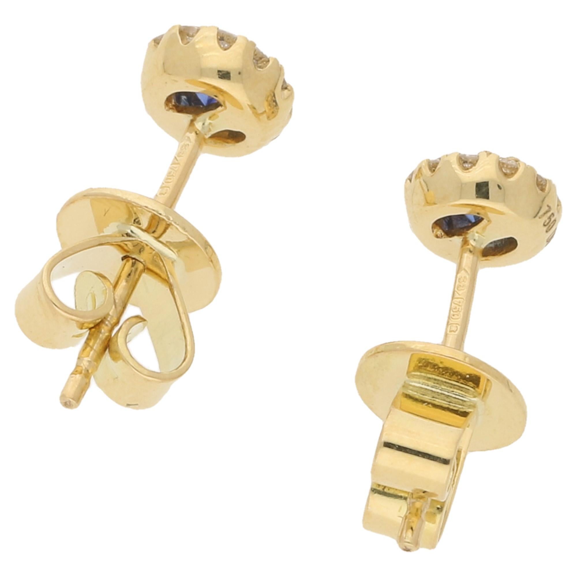  A pair of 18k yellow gold sapphire and diamond cluster stud earrings. The sapphires total 0.31ct's, the diamond's 0.11, G-H colour and VS clarity. The stud measures 6mm across. These are set on post and butterfly fittings.