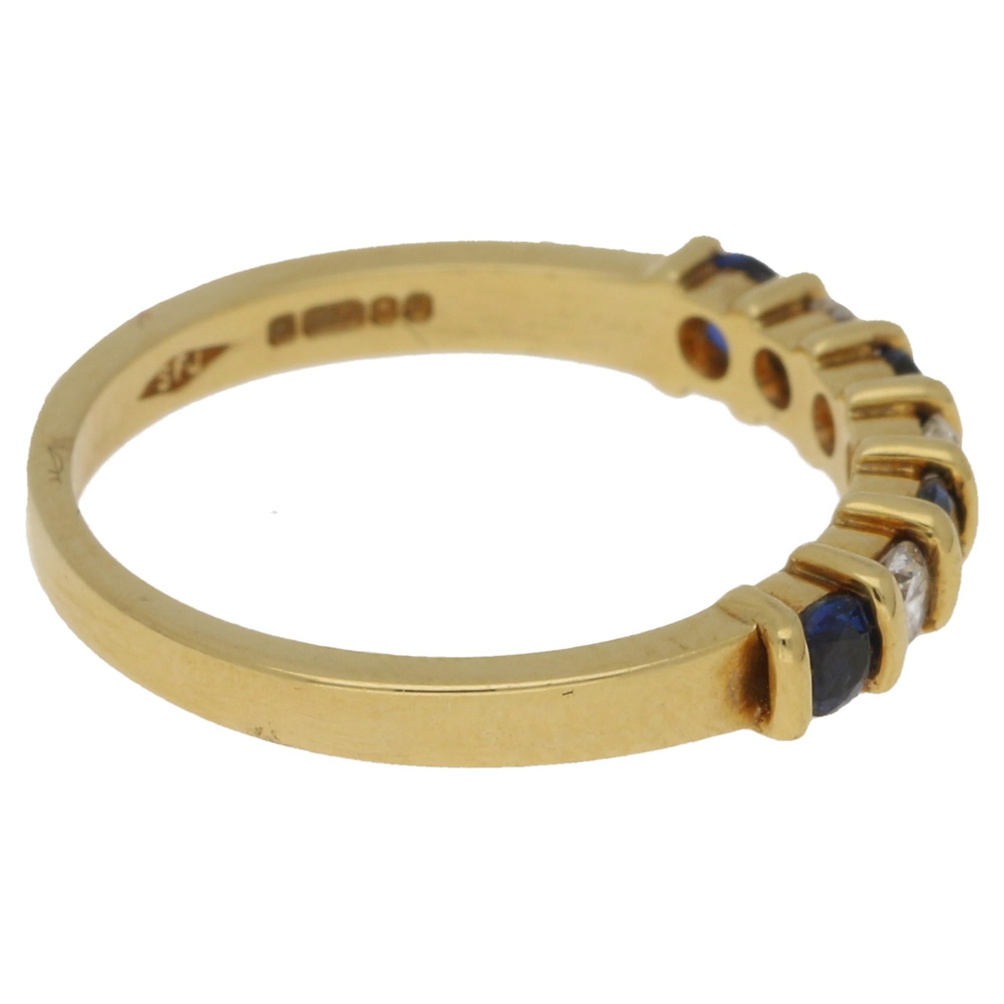 An 18ct yellow gold sapphire and diamond set half eternity ring, Comprising of three round brilliant cut diamonds and four round cut sapphires. Stamped '750' for 18 karat gold. Ring size is presently a K 1/2, this can be adjusted to your finger size.