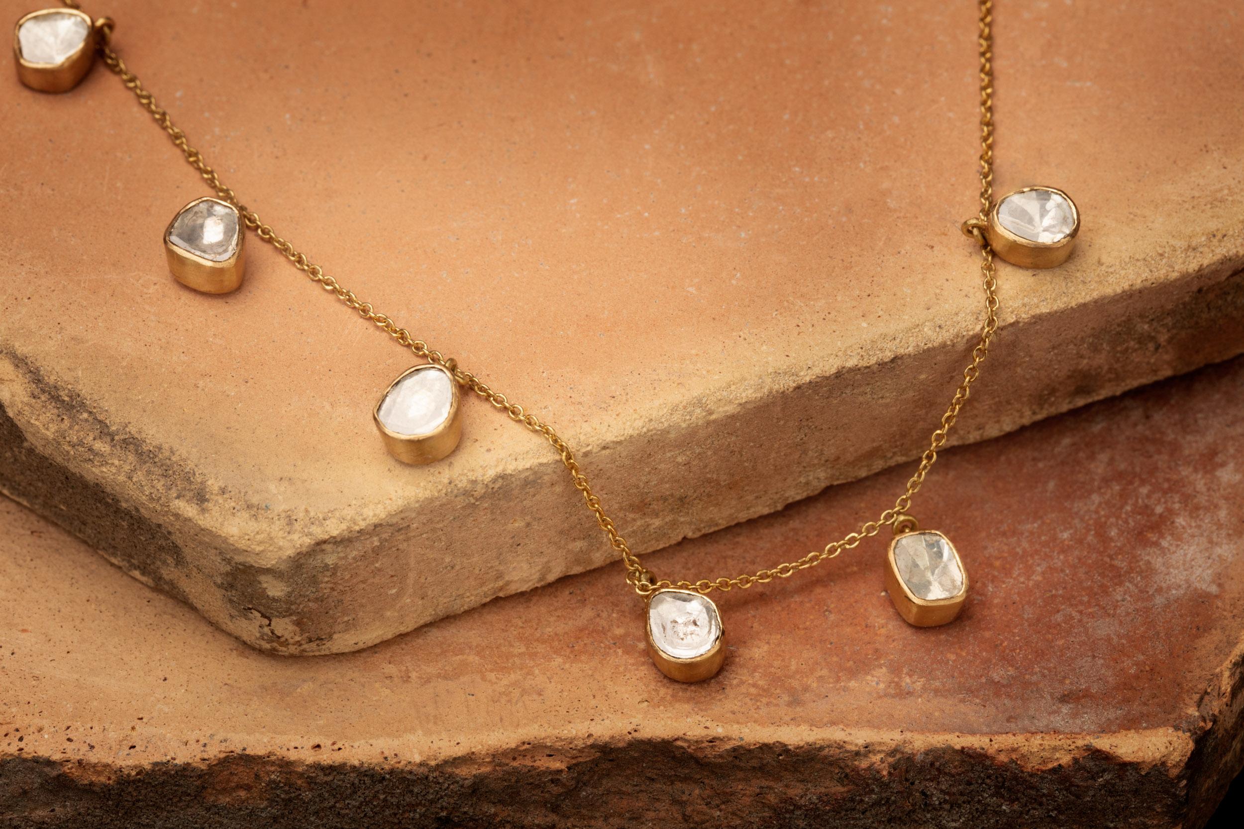 Seven Polki Diamonds garland set in 18 karat gold and hanging along an 17