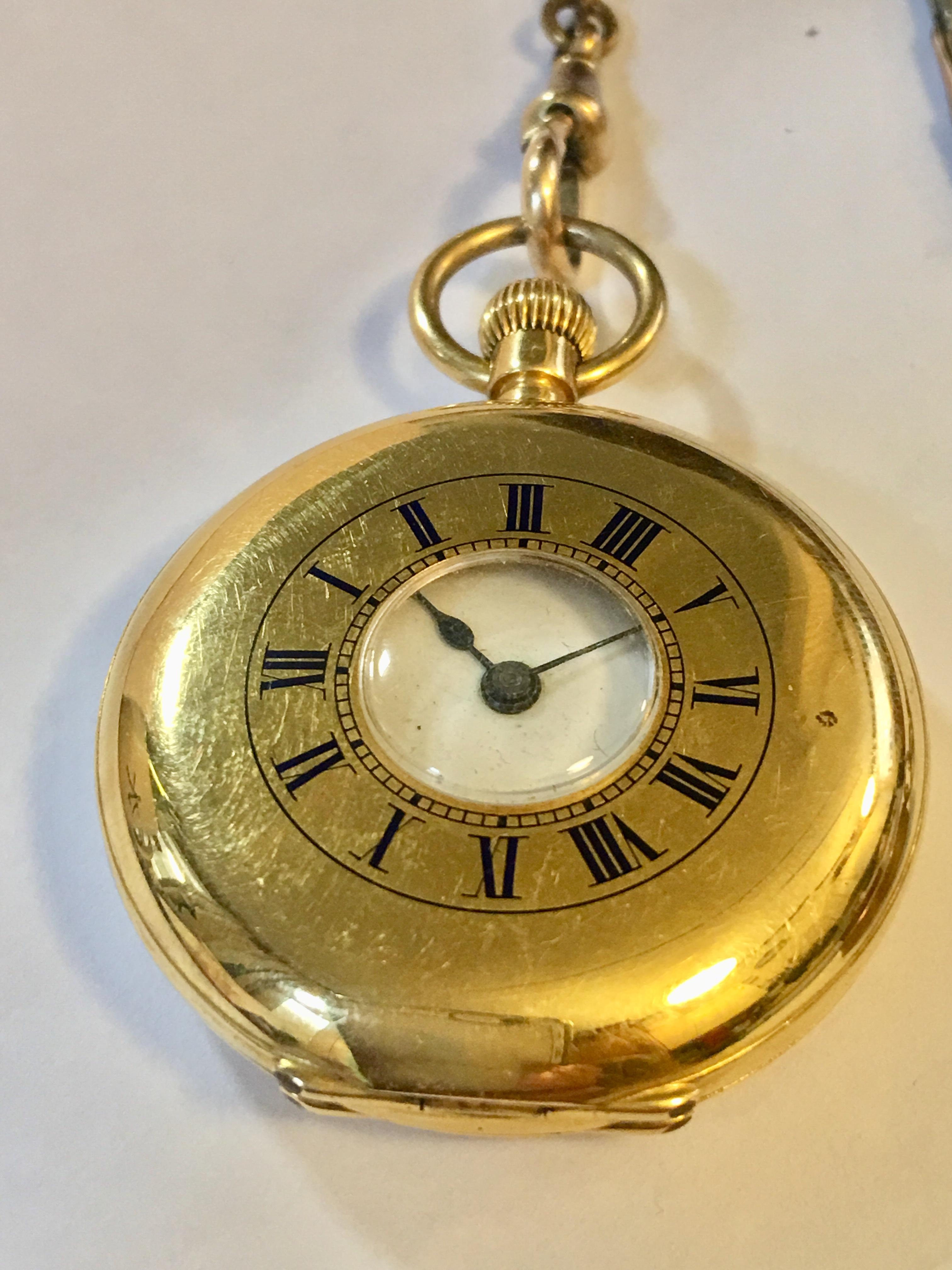 An 18-karat gold half hunter pocket watch with blue enamel chapter ring. The watch has an enamel white dial with black roman numerals. With a smooth stem wind and in a clean condition. The watch also comes with a small chain that has a mini compass.