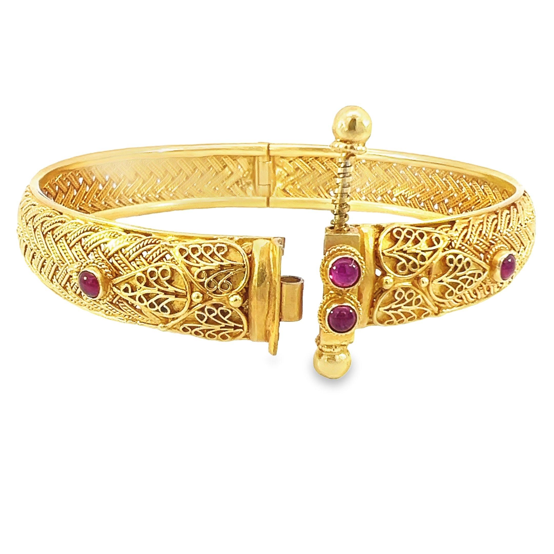 A beautiful solid bangle made with 18-karat yellow gold and feature with 0.95-carat Ruby. 
A stunning timeless piece that exudes. This bangle features a screw lock for further security and a unique, stunning appearance. Bangle has an amazing design