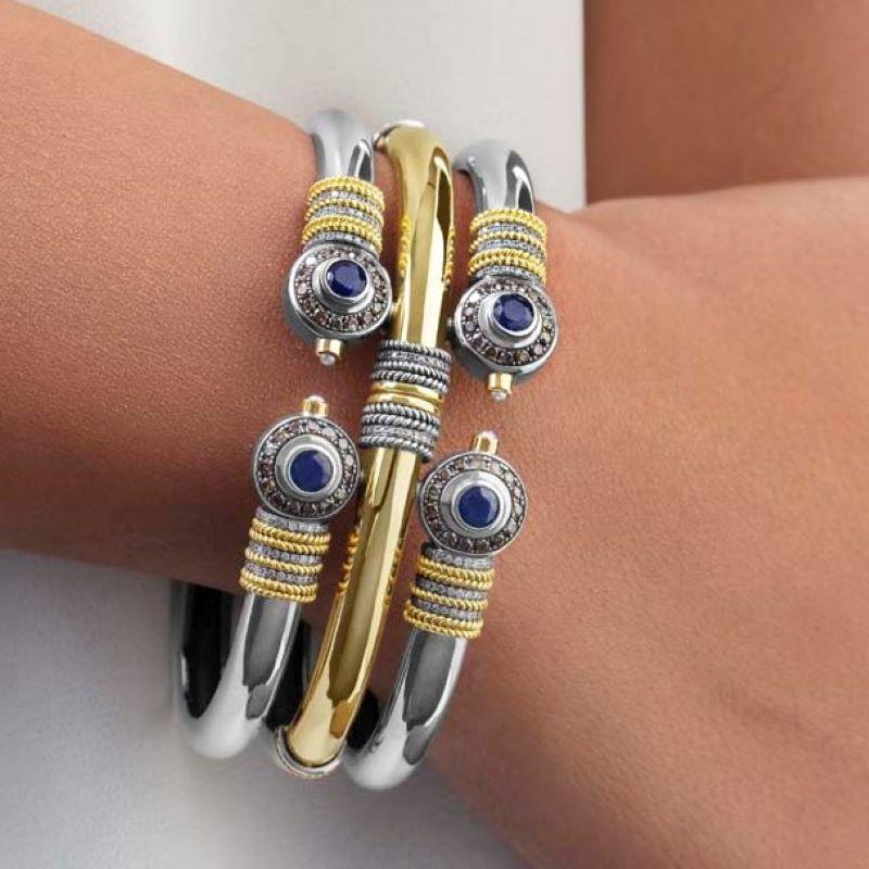 18 Karat Gold, Sterling Silver, 1.76 carat Sapphire, 0.96 carat Champagne Diamond, 0.38 carat Diamond and Cultured Pearl Gypsy Stack Effect Cuff Bangle, with Spring-back hinge closure.

Diameter: 5.8cm
Bangle Width: 2.8cm

Traditional twisted wire