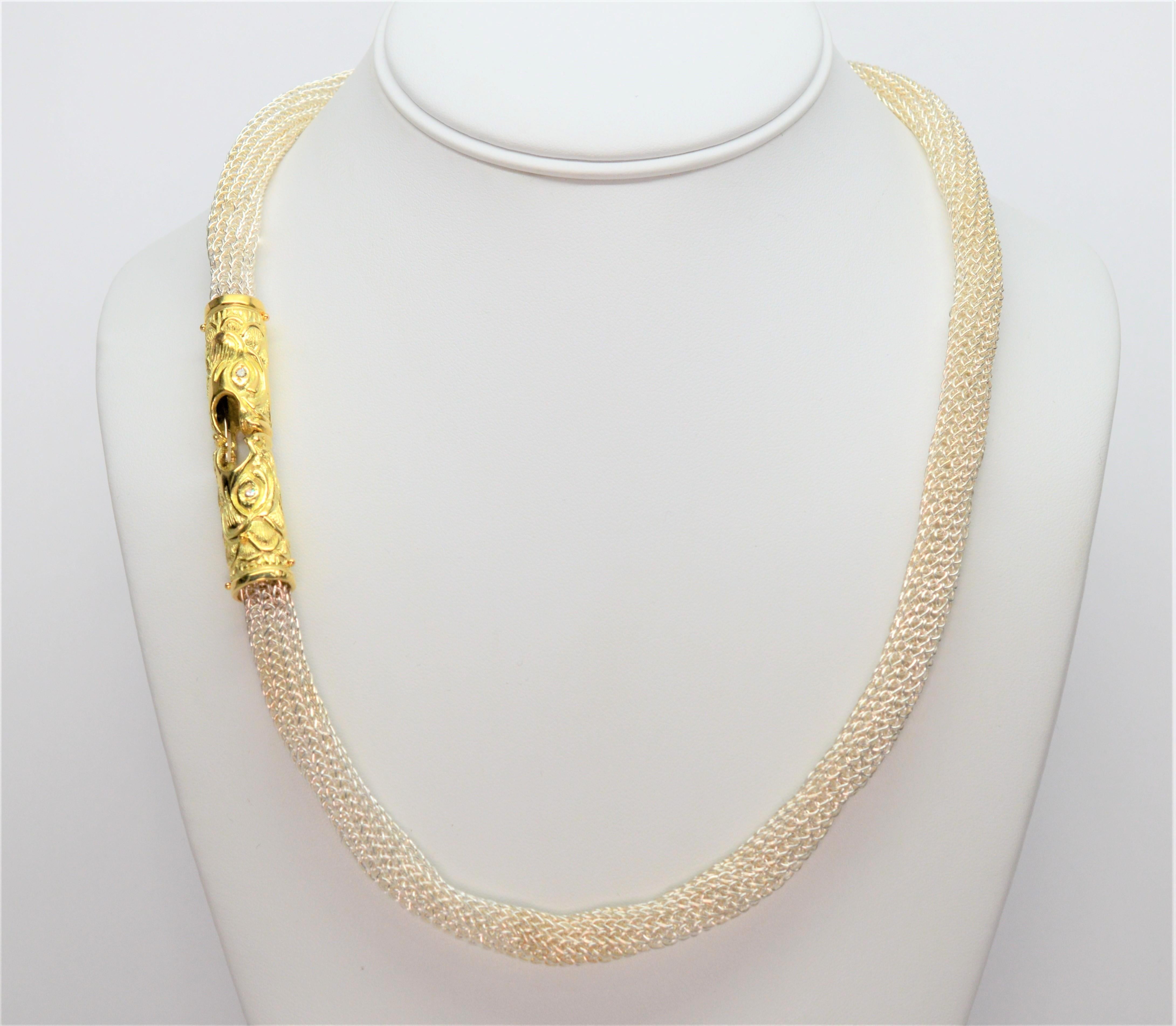 Intriguing 18 Karat Yellow Gold Serpent Heads with Diamond Eyes meet to create this exotic twenty-one inch necklace made of unique Sterling Silver tubular mesh chain.   Gift Boxed.  