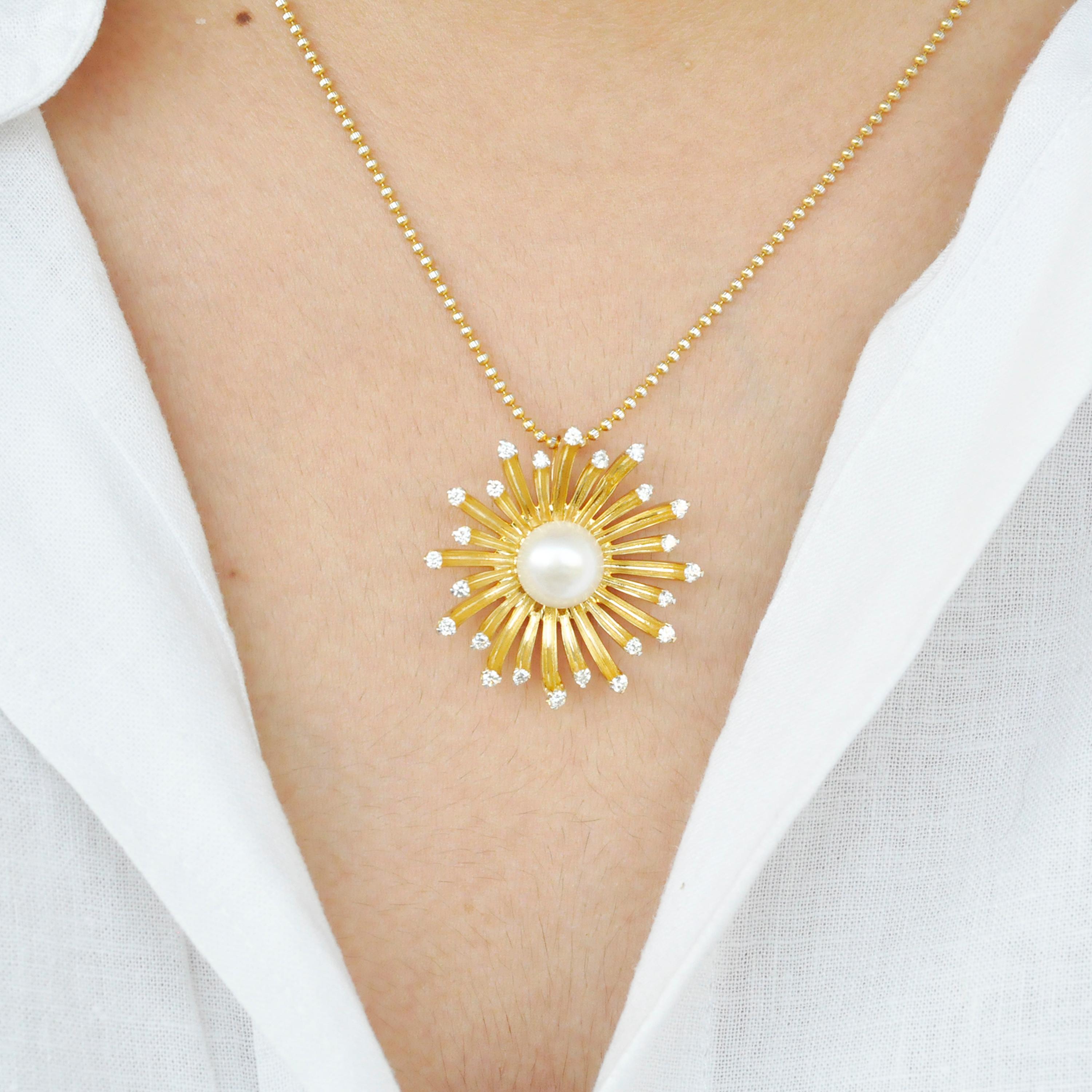 This 18 karat gold diamond pendant necklace is shaped like a blooming flower. The gold in the petals are textured to give it a natural effect, along with the diamonds on the top. A cultured round pearl sitting in the centre adds to the overall