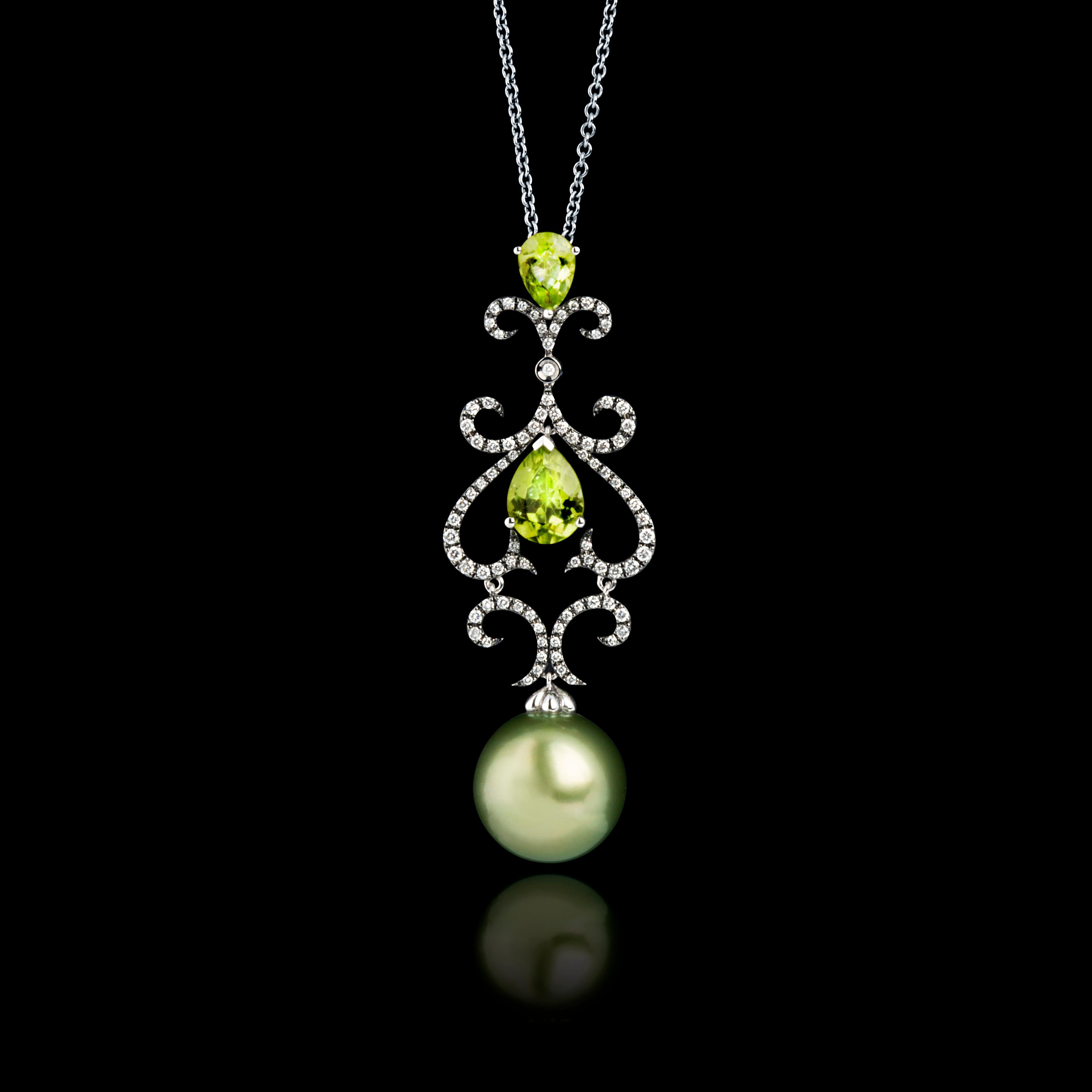 A Tahitian pearls pendant, set with two pear-shaped peridot stones and embellished with small diamonds, mounted in 18 Karat White Gold. This rare natural peacock-green colour pearl of 13.5-14mm is paired with bright green crystal clear peridots