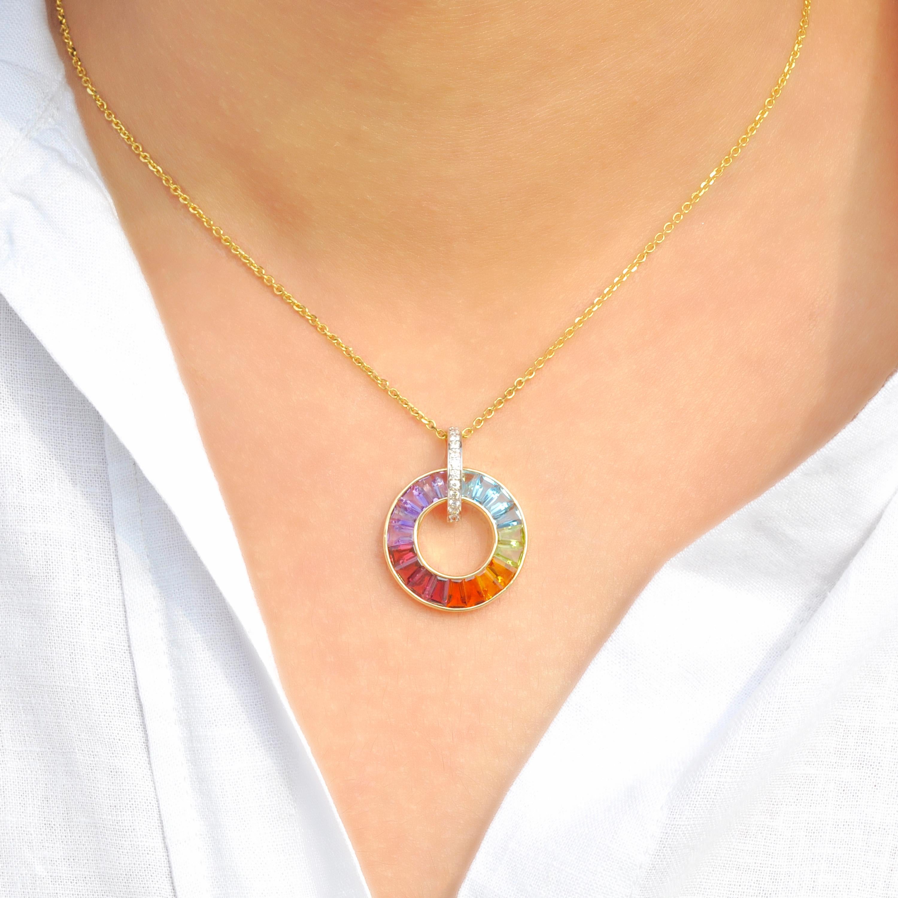This extraordinary 18k gold tapered cut rainbow gemstones diamond art deco inspired circle pendant necklace is a celebration of vibrant hues and unparalleled sophistication. Crafted in luxurious 18-karat gold, this pendant features a captivating