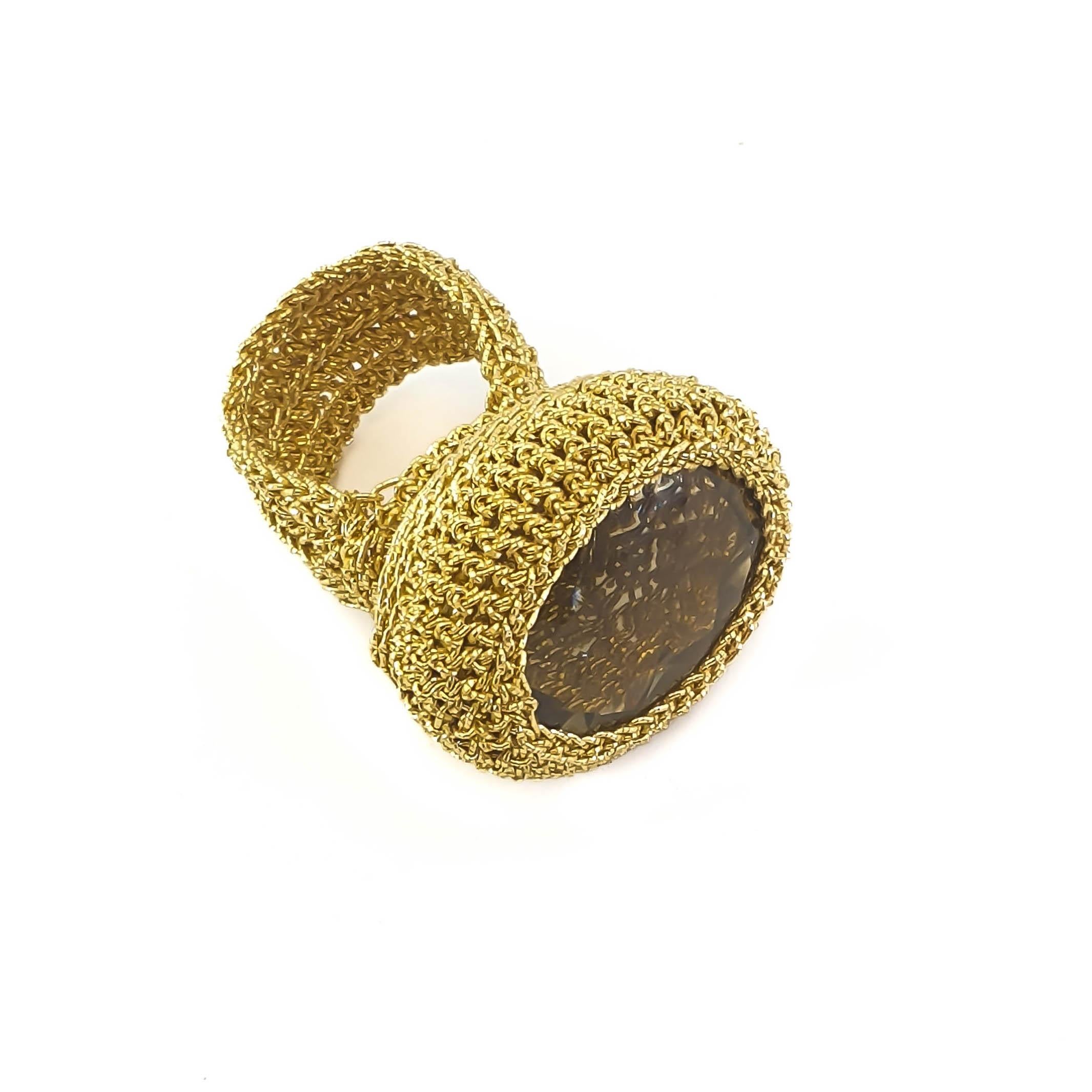 Beautifully crafted hand crochet gold thread (7.26 grams) ring with a natural large Citrine Stone  weighing 9.81 grams (equivalent to 49 carats). The intricate work can be seen through the stone. It is an eye catching ring with a lot of presence.