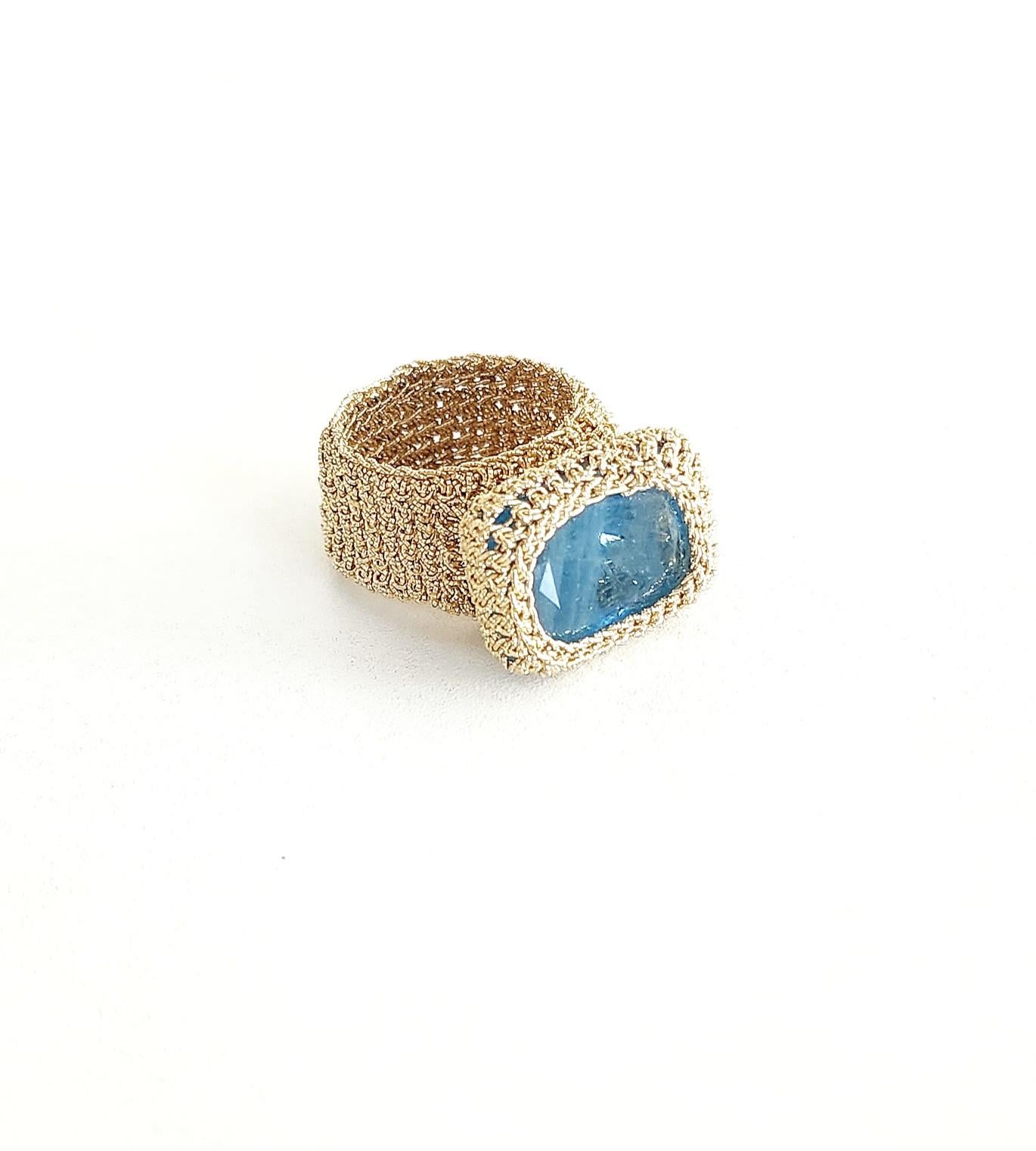 Beautiful, one of a kind crochet ring. It is meticulously handcrafted with 18 karat gold thread. The thread is made of an 18 karat gold wire which is flattened and wrapped around a cotton thread. The stone is a beautiful dark rectangular shaped