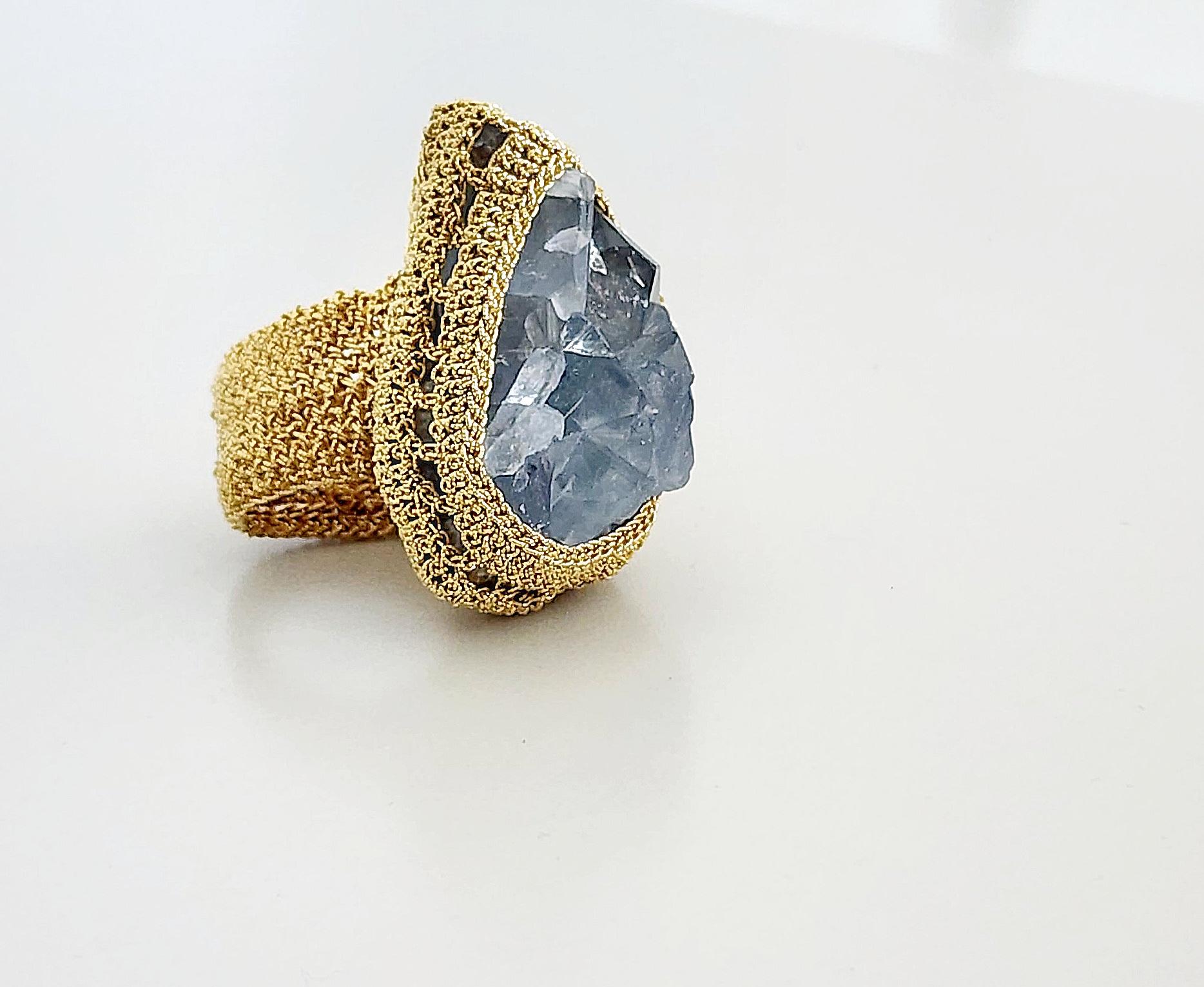 One of a kind, beautiful statement ring. This ring is crochet with an 18 Karat gold thread. The stone is a large rough cut Celestite. This stone is believed to promote communication with the angelic realms. The thread is made from an 18 karat gold