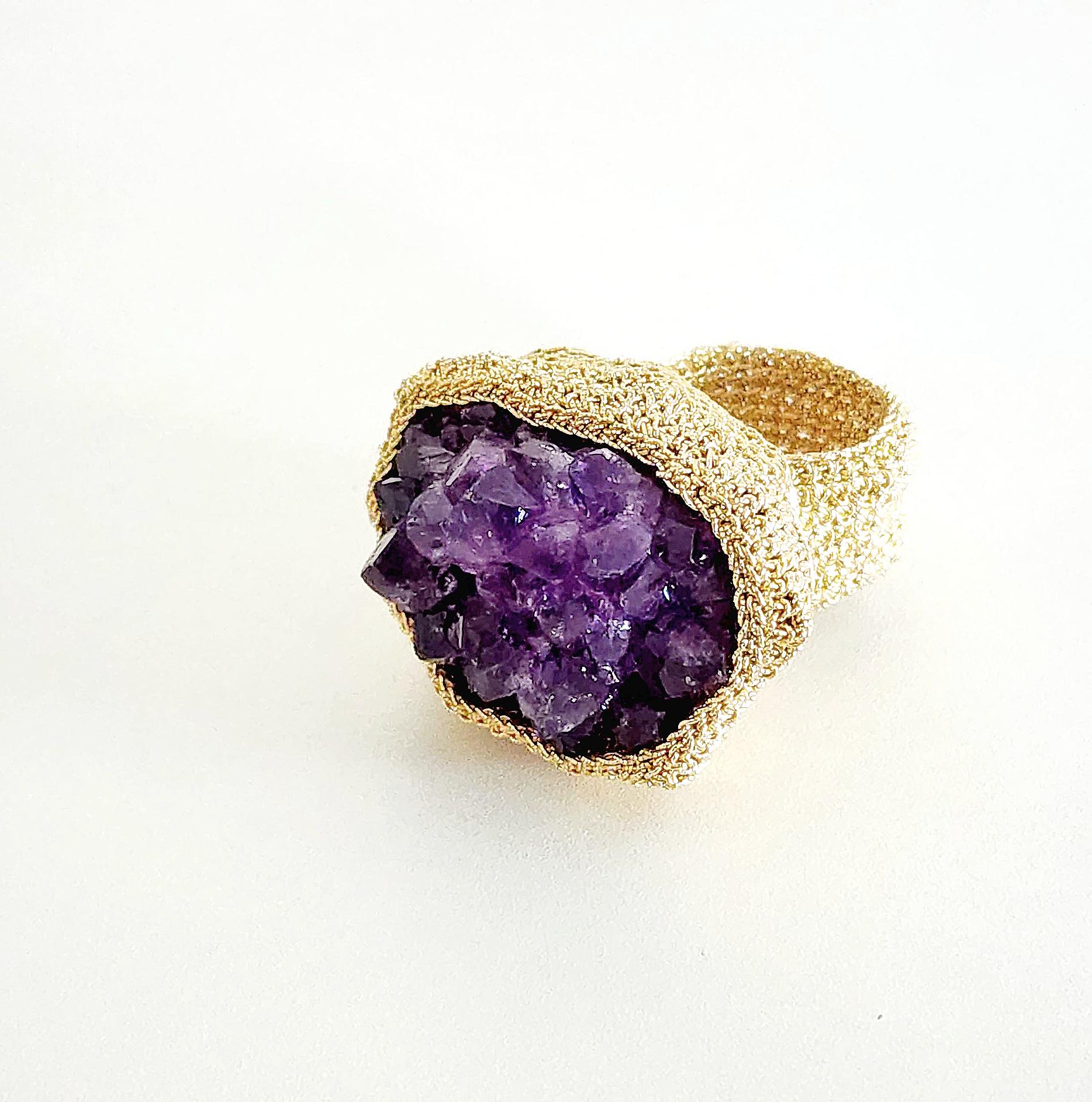 Beautiful, one of a kind crochet ring. It is meticulously handcrafted with 18 karat gold thread. The thread is made of an 18 karat gold wire which is flattened and wrapped around a cotton core. The stone is a beautiful dark rough cut druze Amethyst.