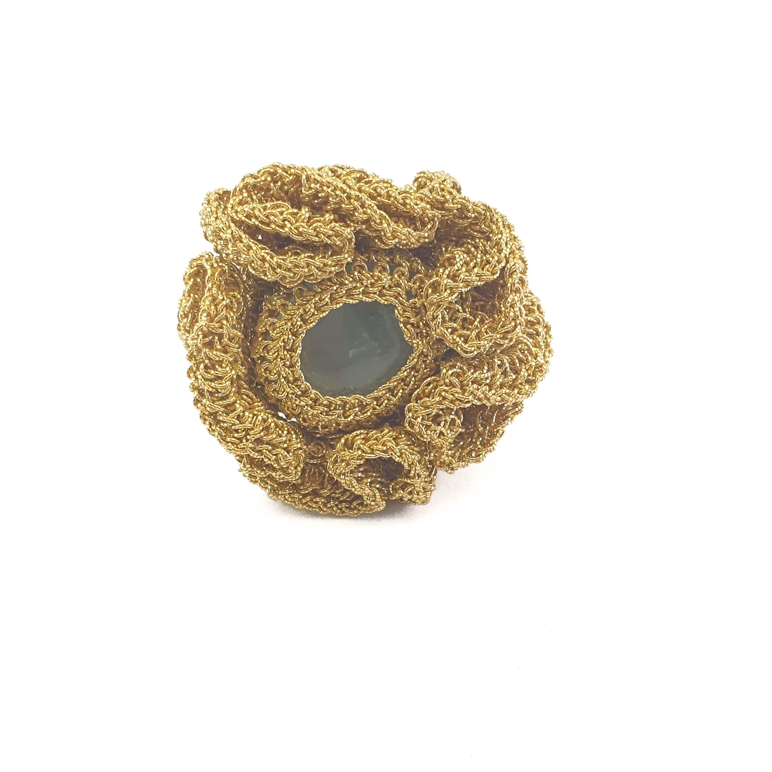 A beautifully crafted, crochet ring. Handmade with 18 Karat gold thread (13.25 grams) and a milky light blue Aquamarine (weighing 1.75 grams/8.75 carats). This ring is a US size 7. It can be stretched a little to fit larger sizes. This ring can be