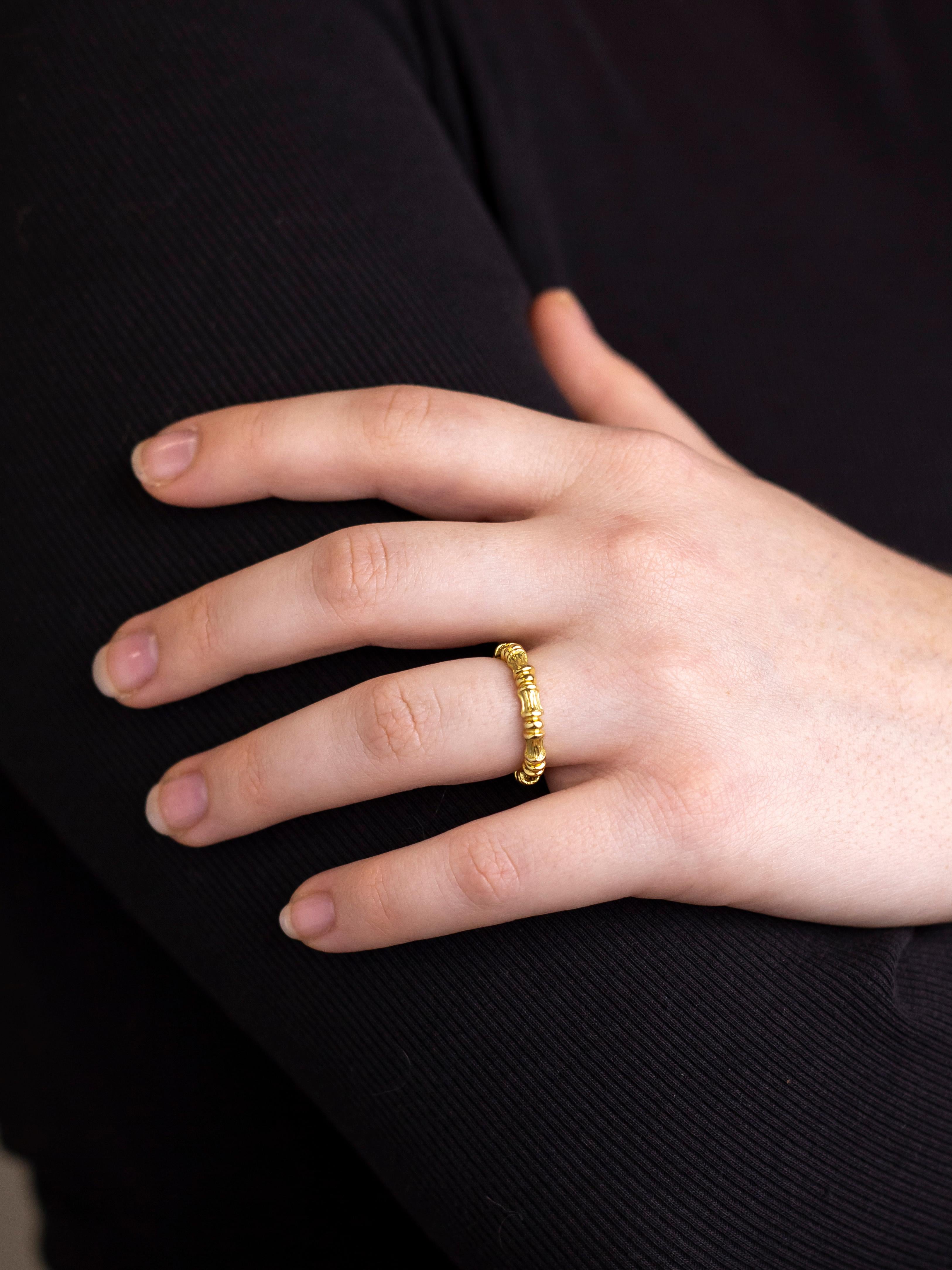 Crafted from 18 karat yellow gold this band which takes the form of bamboo was made by Tiffany and Company. The ring which is perfect for stacking is in lovely condition, however cannot be resized due to its construction with the pattern going