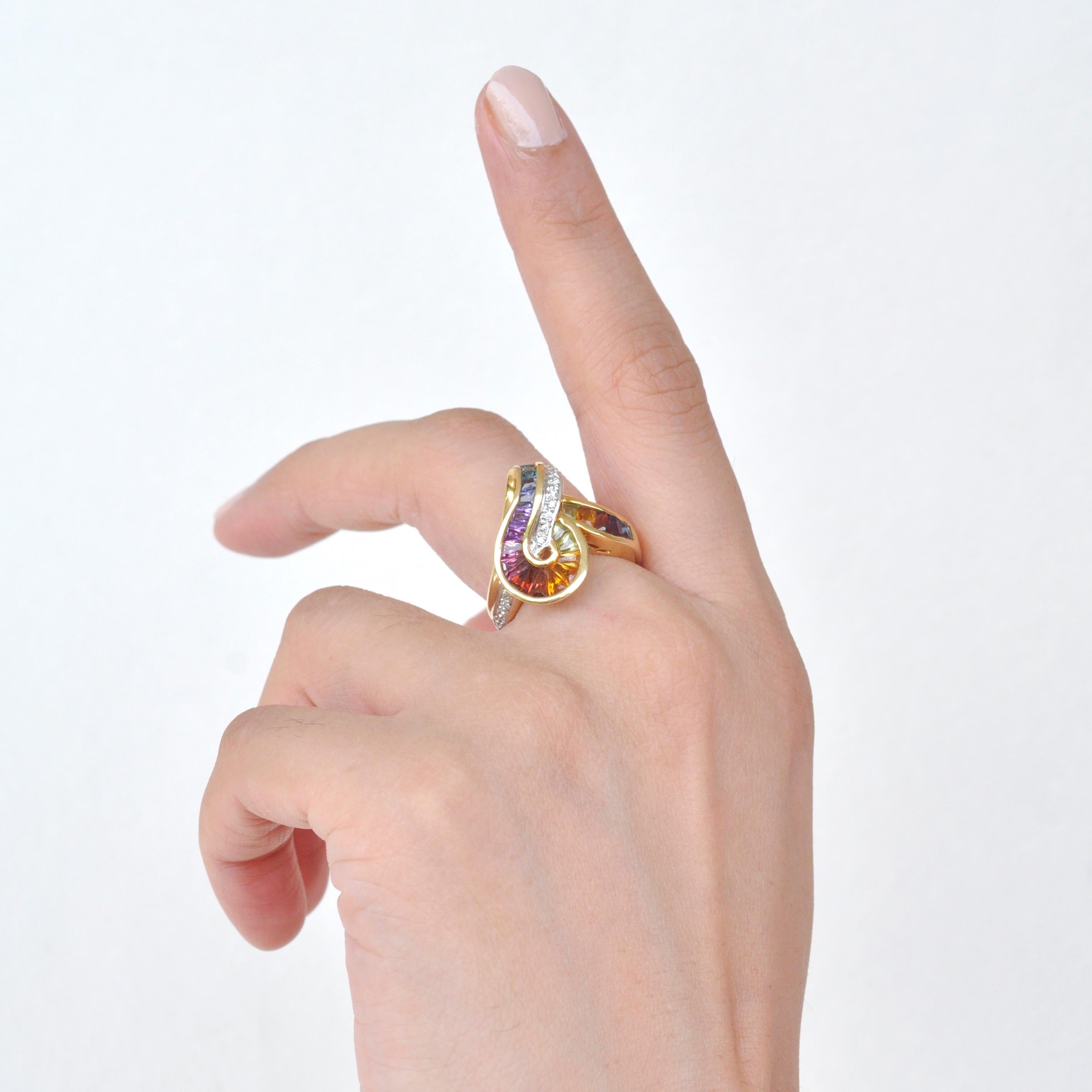 This swirl rainbow ring depicting an artful technique of tapering lustrous natural gemstones and channel setting it to perfectly meet the swirls of the design. A total of 3.96cts of natural gemstones like Amethyst, Garnet, Citrine, Peridot,
